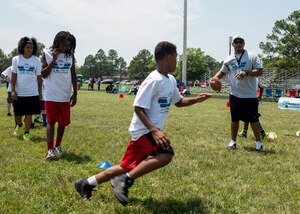 A participant runs a wide receiver route, catches a football during the Pro Camp at Fort Eustis, Va., June 21, 2016. The two-day camp taught military children teamwork and basic physical skills necessary to play football. (U.S. Air Force photo by Airman 1st Class Derek Seifert)