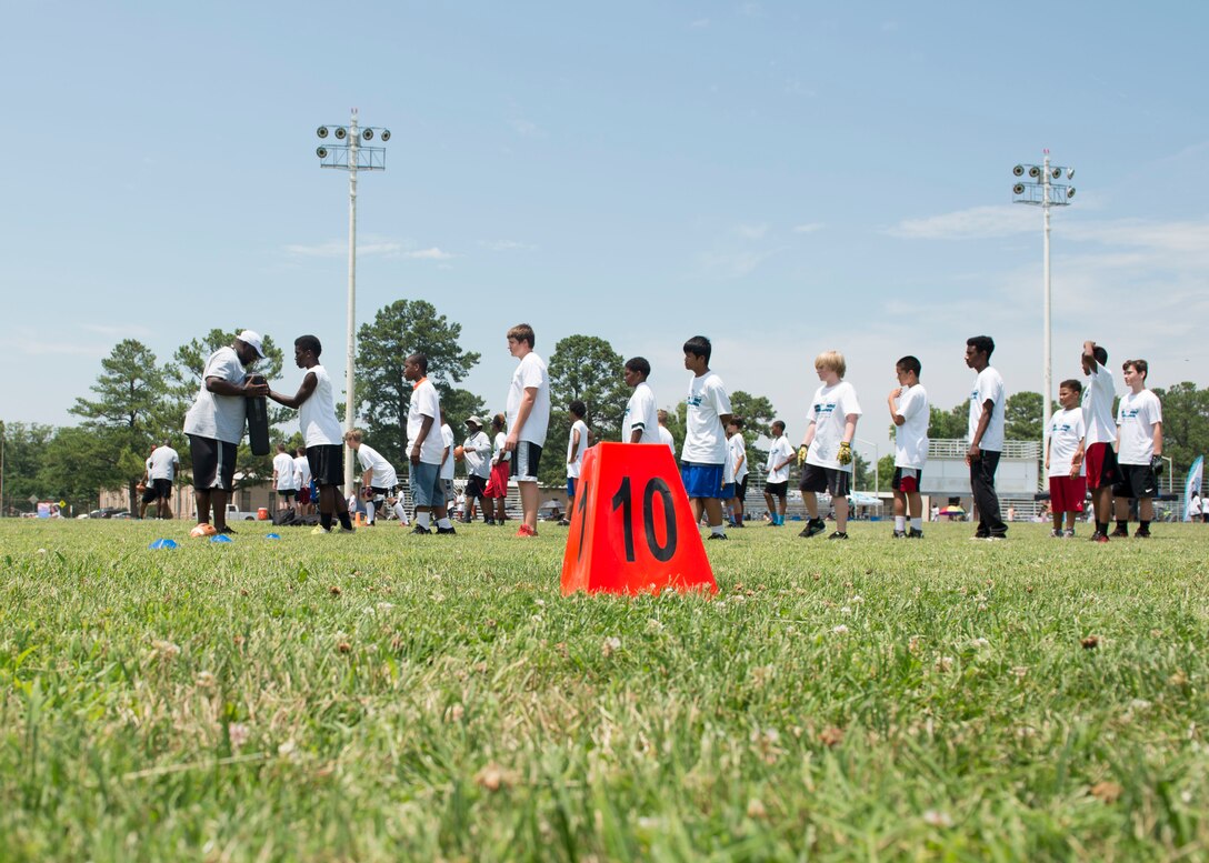 Participants learn techniques to get past a defender during a football Pro Camp at Fort Eustis, Va., June 21, 2016. About 150 participants were broken up into three age groups, each named after Carolina Panthers running back Jonathan Stewart's high school team, his college team and professional team. (U.S. Air Force photo by Airman 1st Class Derek Seifert)