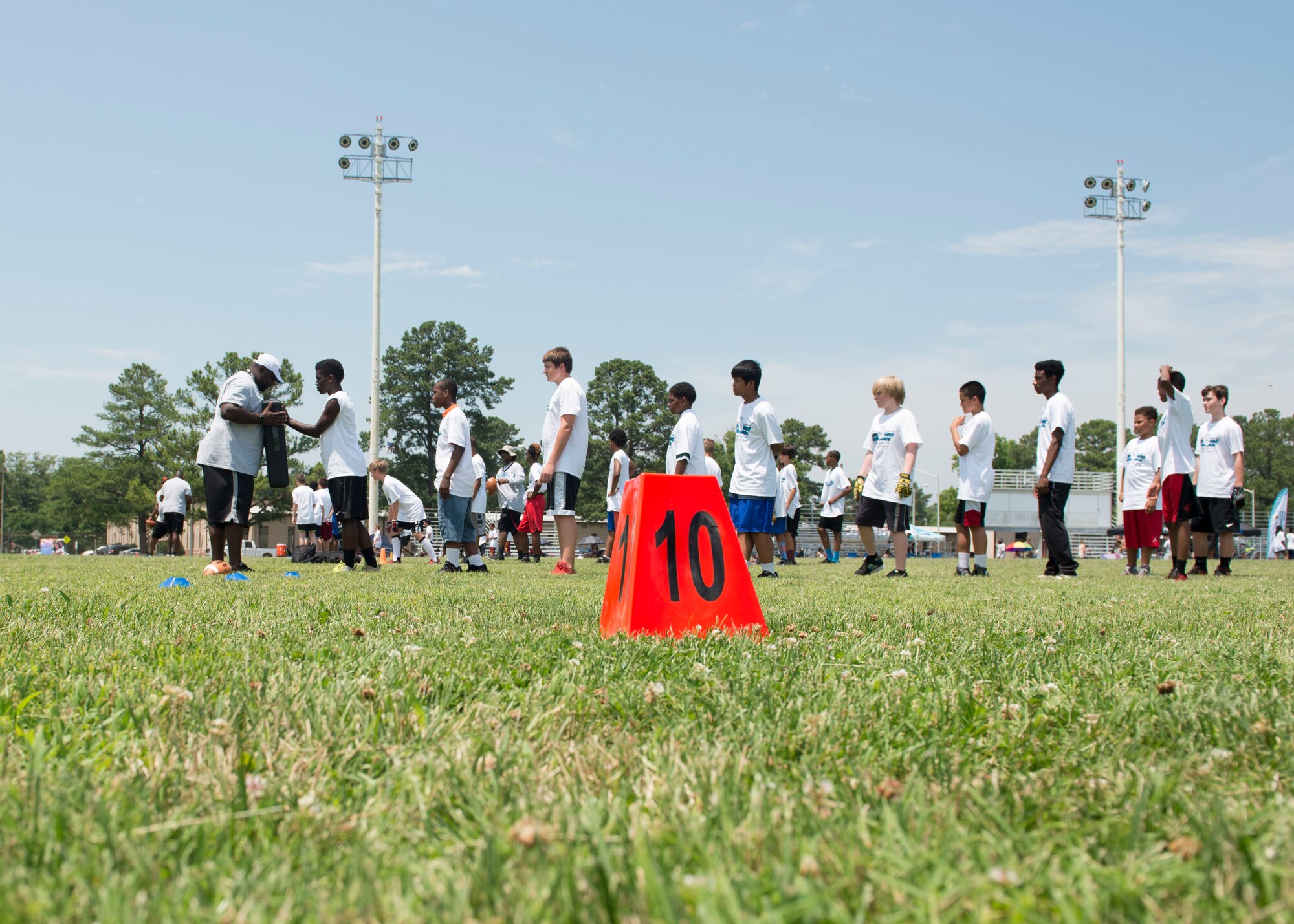 Participants learn techniques to get past a defender during a football Pro Camp at Fort Eustis, Va., June 21, 2016. About 150 participants were broken up into three age groups, each named after Carolina Panthers running back Jonathan Stewart's high school team, his college team and professional team. (U.S. Air Force photo by Airman 1st Class Derek Seifert)