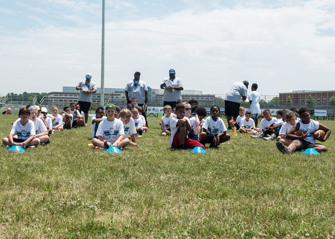 Participants wait for Carolina Panthers running back Jonathan Stewart to give his opening remarks before the start of a football Pro Camp at Fort Eustis, Va., June 21, 2016. Stewart grew up in a military family as his father was stationed at Fort Lewis, Wash., and his brother is serving in the U.S. Army at Fort Eustis. (U.S. Air Force photo by Airman 1st Class Derek Seifert)