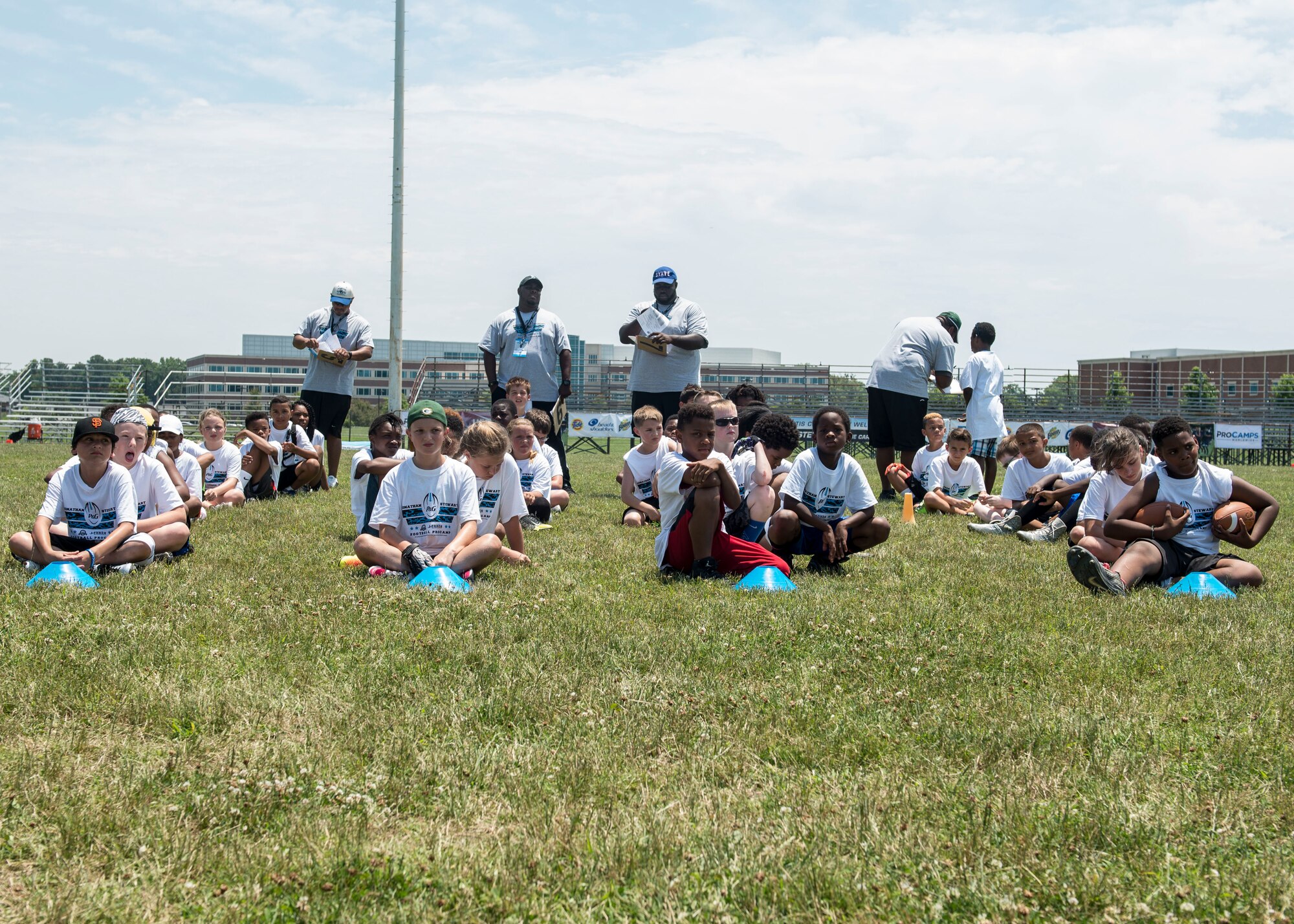Participants wait for Carolina Panthers running back Jonathan Stewart to give his opening remarks before the start of a football Pro Camp at Fort Eustis, Va., June 21, 2016. Stewart grew up in a military family as his father was stationed at Fort Lewis, Wash., and his brother is serving in the U.S. Army at Fort Eustis. (U.S. Air Force photo by Airman 1st Class Derek Seifert)