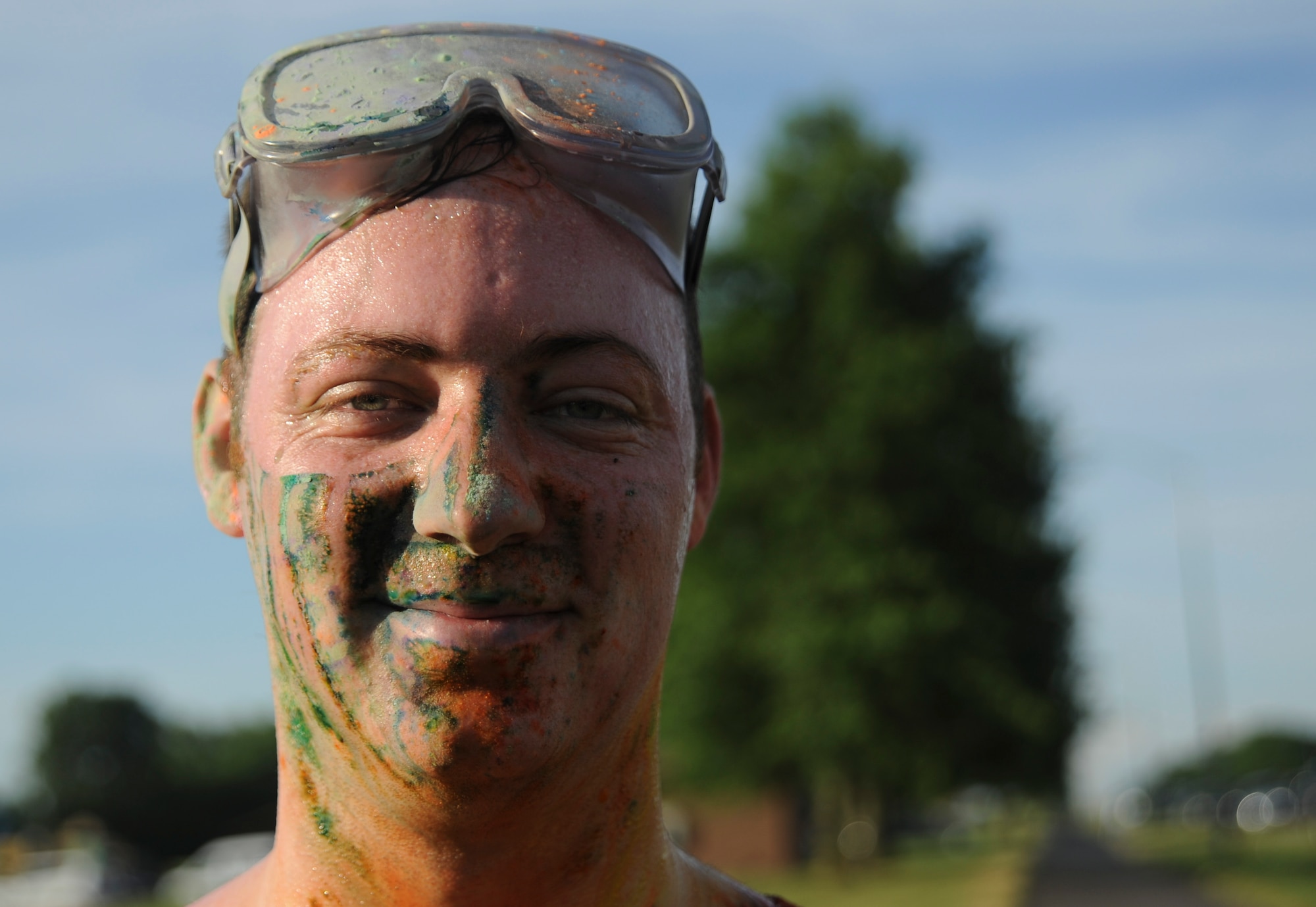U.S. Air Force Airman 1st Class Zachary Taylor, a participant of the Lesbian, Gay, Bisexual and Transgender Pride Month Rainbow Run 5K, displays the effects of the colored powder after the run at Whiteman Air Force Base, Mo., June 24, 2016. Participants were given eye protection before the run to ensure their safety. (U.S. Air Force photo by Senior Airman Danielle Quilla)