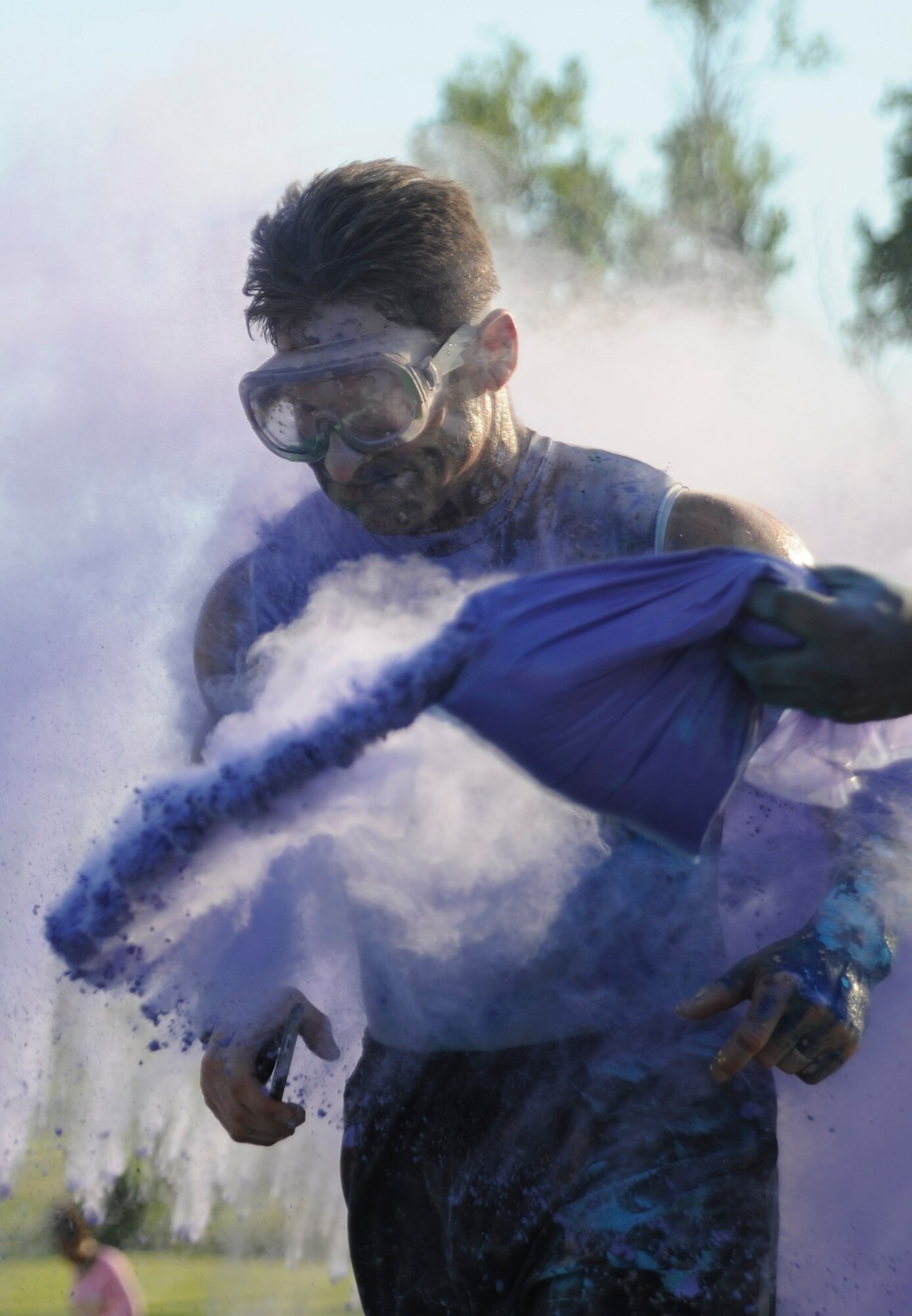 U.S. Air Force Lt. Col. Daniel Murray, a participant of the Lesbian, Gay, Bisexual and Transgender (LGBT) Pride Month Rainbow Run 5K, runs through a cloud of colored powder at Whiteman Air Force Base, Mo., June 24, 2016. The run was one of the LGBT Pride Month events celebrating the great diversity of the American people. (U.S. Air Force photo by Senior Airman Danielle Quilla)