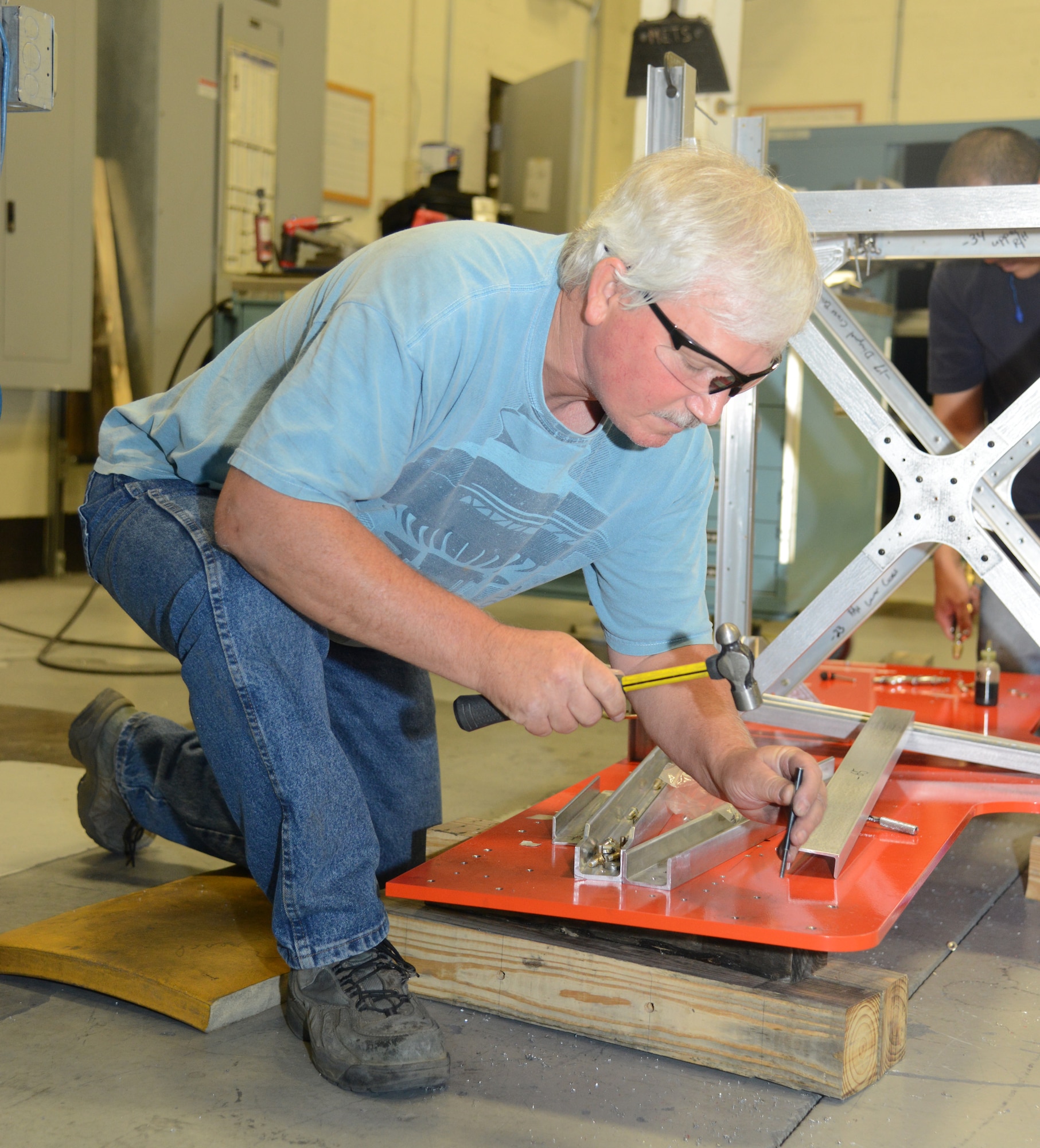 Joe Beachboard, a model maker with the 412th Maintenance Squadron Instrumentation Division, installs threaded inserts in the base of the flight test engineer workstation scheduled to be used for KC-46 testing. Engineers, model makers and technicians worked closely to design and construct the workstations. The modular design of the station allows for easier construction, installation and reconfiguration. (U.S. Air Force photo by Christopher Ball)