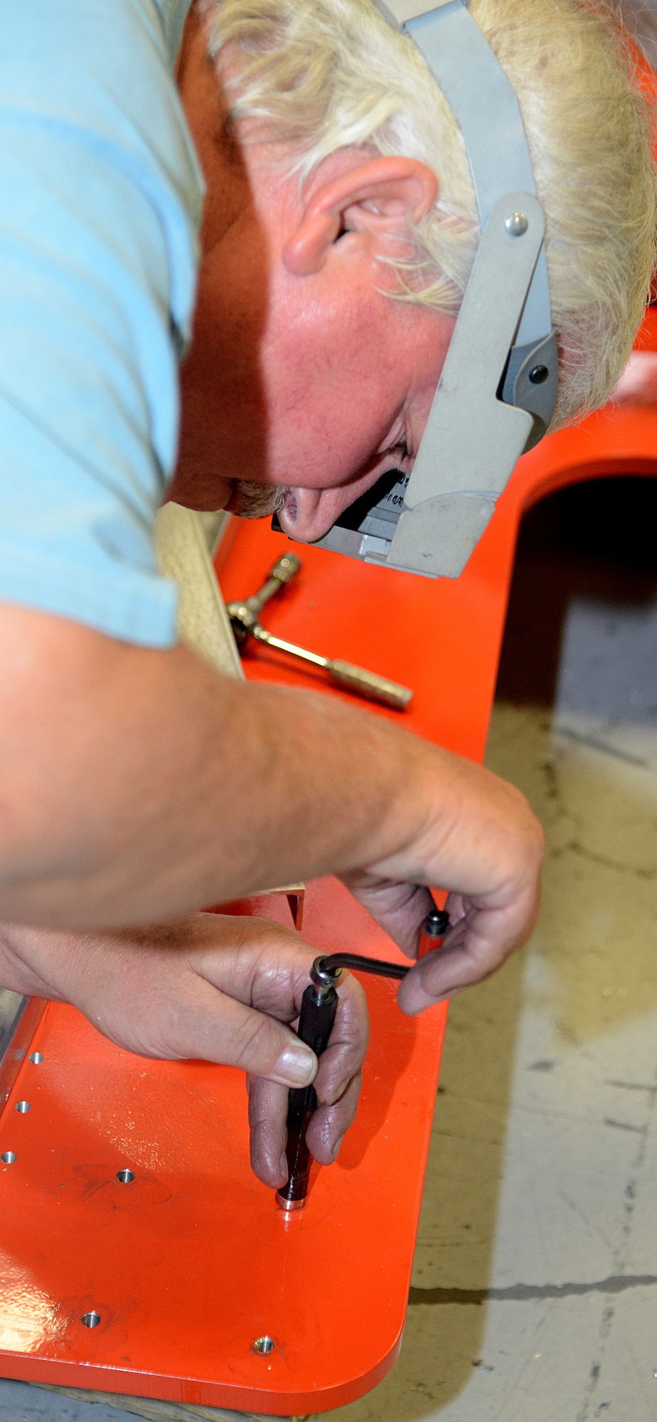 Joe Beachboard, a model maker with the 412th Maintenance Squadron Instrumentation Division, installs threaded inserts in the base of the flight test engineer workstation scheduled to be used for KC-46 testing. Engineers, model makers and technicians worked closely to design and construct the workstations. The modular design of the station allows for easier construction, installation and reconfiguration. (U.S. Air Force photo by Christopher Ball)