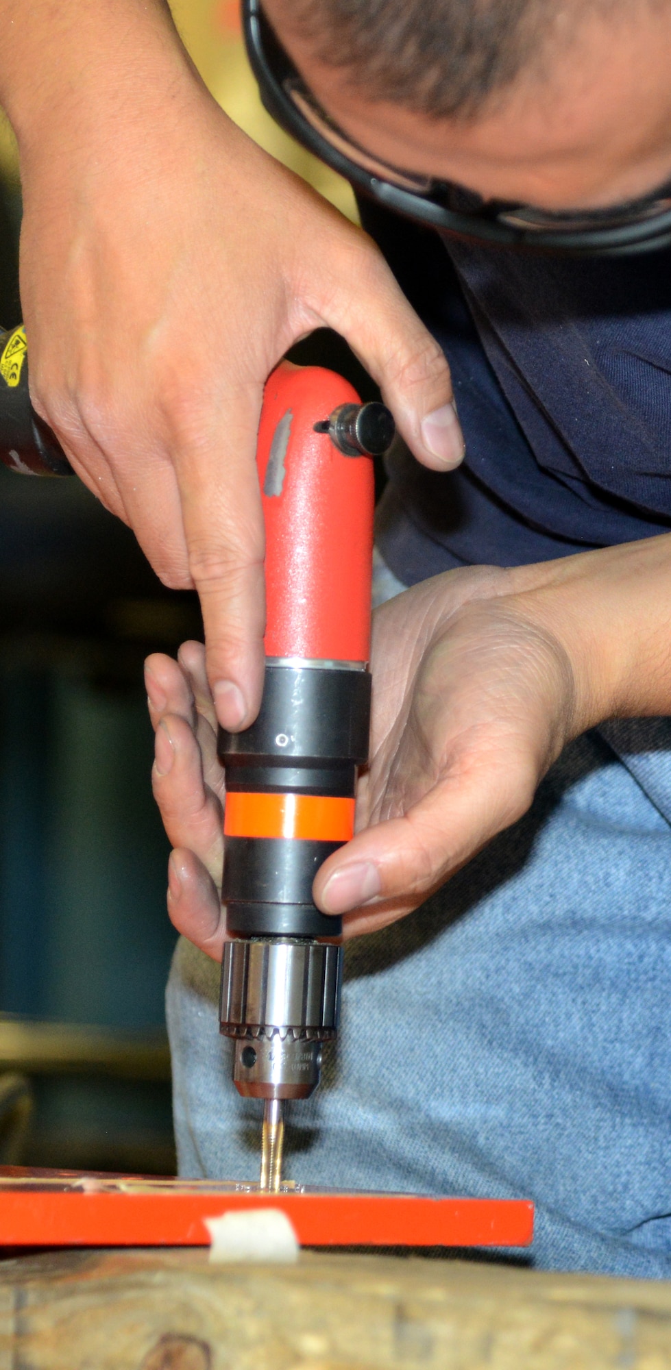 Rafiq Viray, a model maker with the 412th Maintenance Squadron Instrumentation Division, threads mount holes in the base of the flight test engineer workstation scheduled to be used for KC-46 testing. The workstation was designed in modules for ease of construction, installation, and reconfiguration. (U.S. Air Force photo by Christopher Ball)
