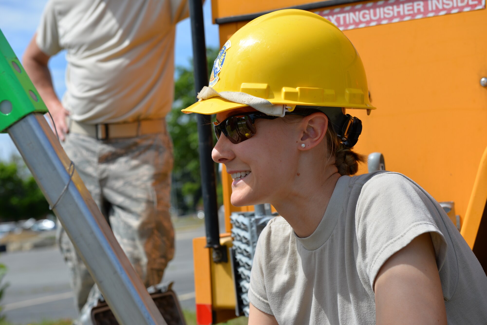 Staff Sgt. Chelsea Kennie, 243rd Engineering Installation Squadron radio frequency transmission technician, smiles after removing outdated coaxial cable from a manhole at Pease Air National Guard Base, N.H., June 17. The team from Portland, M.E. has assisted the 157th Communications Flight with removing over 20,000 feet of cable from manholes at Pease ANGB. (U.S. Air National Guard photo by Tech. Sgt. Erica Rowe)