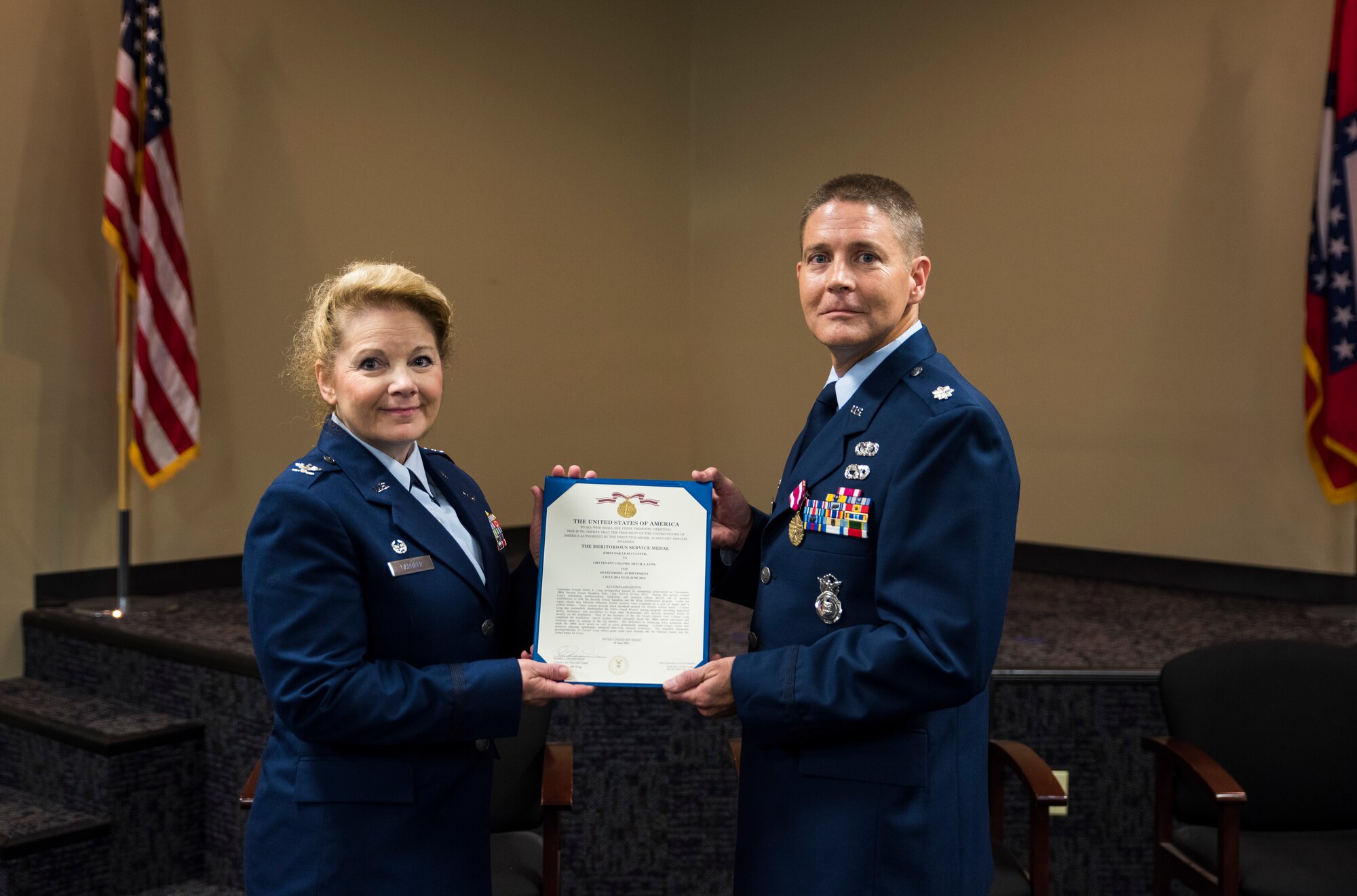 Lt. Col. Mitch Long, 188th Mission Support Group deputy commander and previous 188th Security Forces commander, is awarded the Meritorious Service Medal, first oak leaf cluster, by Col. Tenise Gardner, 188th MSG commander, June 26, 2016, for his outstanding achievement as commander of the 188th SFS at Ebbing Air National Guard Base, Fort Smith, Ark. Maj. Heath Allen, previous 188th Wing executive officer, took command of the 188th SFS during the ceremony. (U.S. Air National Guard photo by Senior Airman Cody Martin/Released)