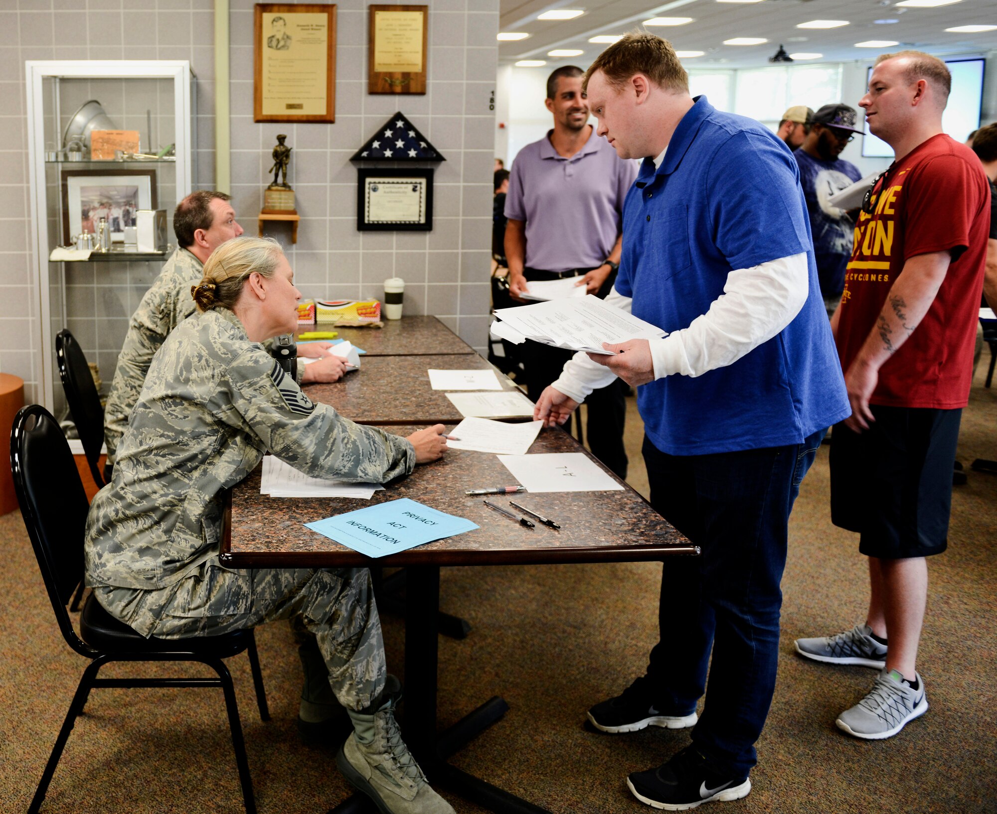 Individual Ready Reserve Airman wait in processing lines during the annual IRR Muster hosted by the 132nd Wing, on June 24 in Des Moines, Iowa. The muster was held to update records and assess the readiness of these inactive reservists. (U.S. Air National Guard photo by Airman Katelyn S. Sprott/ Released)



