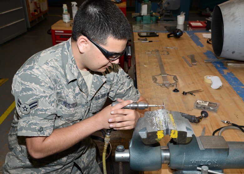 Airman 1st Class Robert Wierzbicki uses a pneumatic vice drill to create holes in sheet metal used to make parts for the A-10 June 22, 2016 at Warfield Air National Guard Base, Middle River, Md. Wierzbicki is the Maryland Air National Guard July Spotlight Airman. (U.S. Air National Guard photo by Airman 1st Class Enjoli Saunders/RELEASED) 