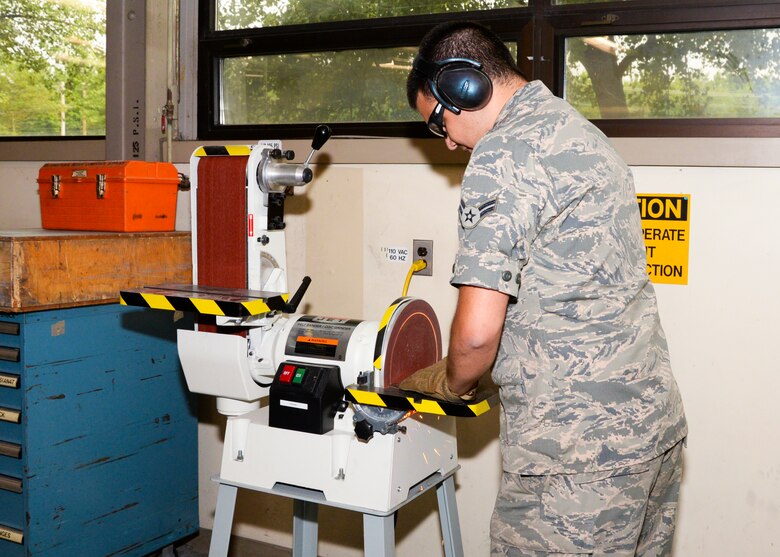 Airman 1st Class Robert Wierzbicki uses a belt sander to form sheet metal to specific measurements June 22, 2016 at Warfield Air National Guard Base, Middle River, Md. Wierzbicki is the Maryland Air National Guard July Spotlight Airman. (U.S. Air National Guard photo by Airman 1st Class Enjoli Saunders/RELEASED) 