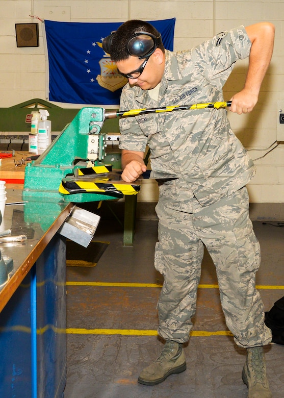 Airman 1st Class Robert Wierzbicki cuts a piece of metal using a 90 degree metal shear June 22, 2016 at Warfield Air National Guard Base, Middle River, Md. Wierzbicki is the Maryland Air National Guard July Spotlight Airman. (U.S. Air National Guard photo by Airman 1st Class Enjoli Saunders/RELEASED) 