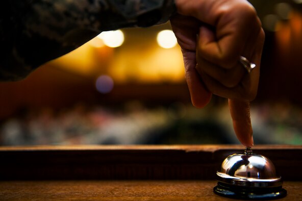 U.S. Air Force Senior Master Sgt. Nicole Dismute, 52nd Medical Support Squadron medical logistics flight chief, rings a bell during a speed mentoring session at Club Eifel on Spangdahlem Air Base, Germany, June 28, 2016. Thirty-four company grade officers and senior NCOs participated in the mentoring session, rotating every three minutes. (U.S. Air Force photo by Airman 1st Class Timothy Kim/Released)