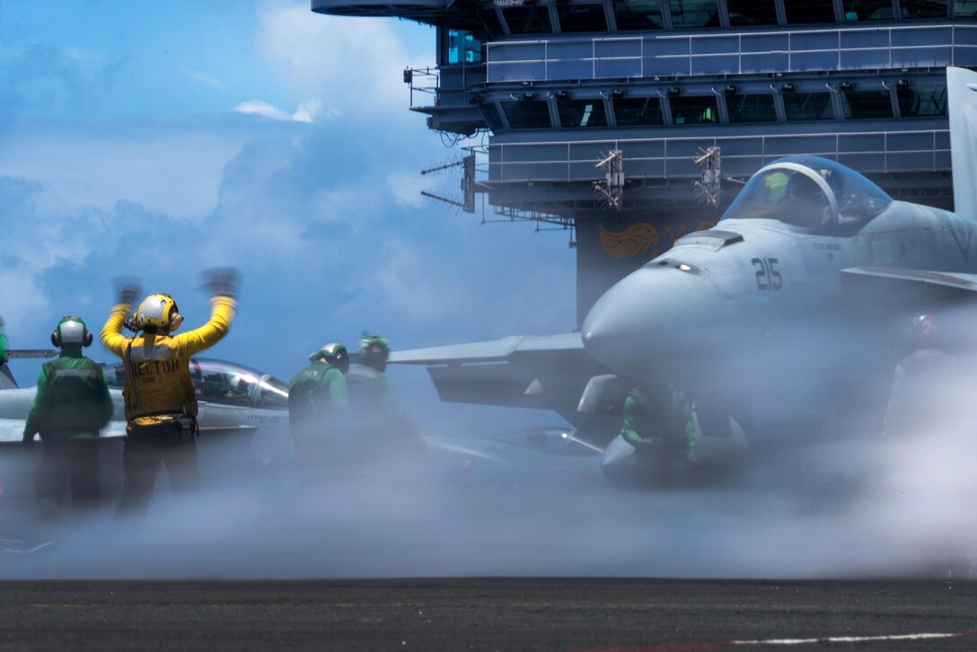 Navy Seaman Nohemi Cervantes Mendoza, left, directs an F/A-18E Super Hornet on the USS John C. Stennis flight deck in the Pacific Ocean, June 27, 2016. Mendoza is an aviation boatswain’s mate handling, airman. The Stennis is on a regularly scheduled Western Pacific deployment. Navy photo by Petty Officer 3rd Class Kenneth Rodriguez Santiago