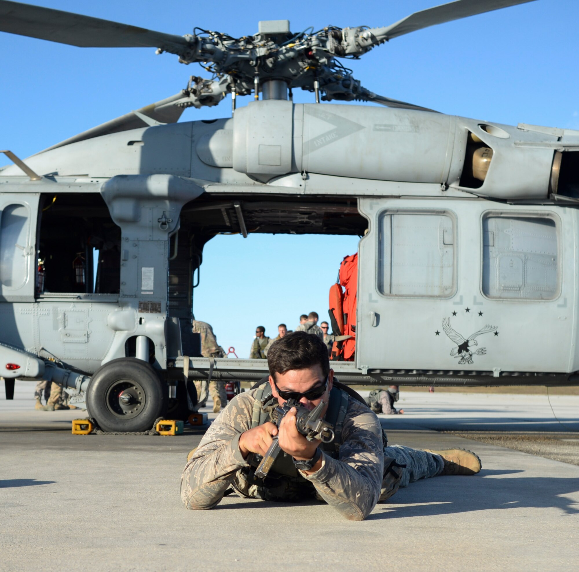 Capt. Michael Winter, Jungle Training Operations Course student with the 736th Security Forces Squadron, scans the area for enemy combatants during an air assault exercise June 15, 2016, at Andersen Air Force Base, Guam. From June 15-21, instructors from the U.S. Army 25th Infantry Division’s Lightning Academy Jungle Operations Training Center, in Schofield Barracks, Hawaii, travelled to Guam to teach more than 30 Airmen and Soldiers the fundamentals of fighting and surviving in jungles with support from cadre members of the 736th Security Forces Squadron. (U.S. Air Force photo by Tech. Sgt. Richard Ebensberger)