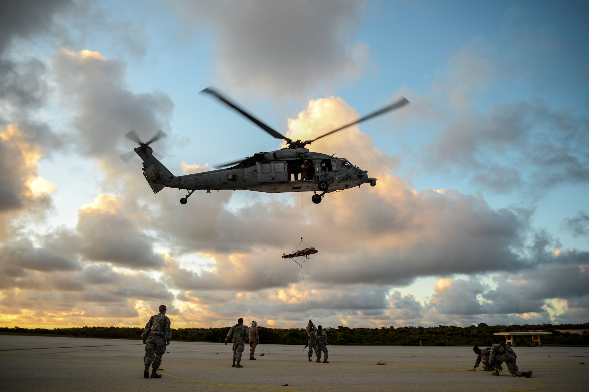 Airmen and Soldiers conduct medical evacuation training with an MH-60 Seahawk during the Jungle Training Operations Course June 15, 2016, at Andersen Air Force Base, Guam. During the course, students also learned jungle survival skills, including land navigation, water purification and evasion techniques. (U.S. Air Force photo by Tech. Sgt. Richard Ebensberger)