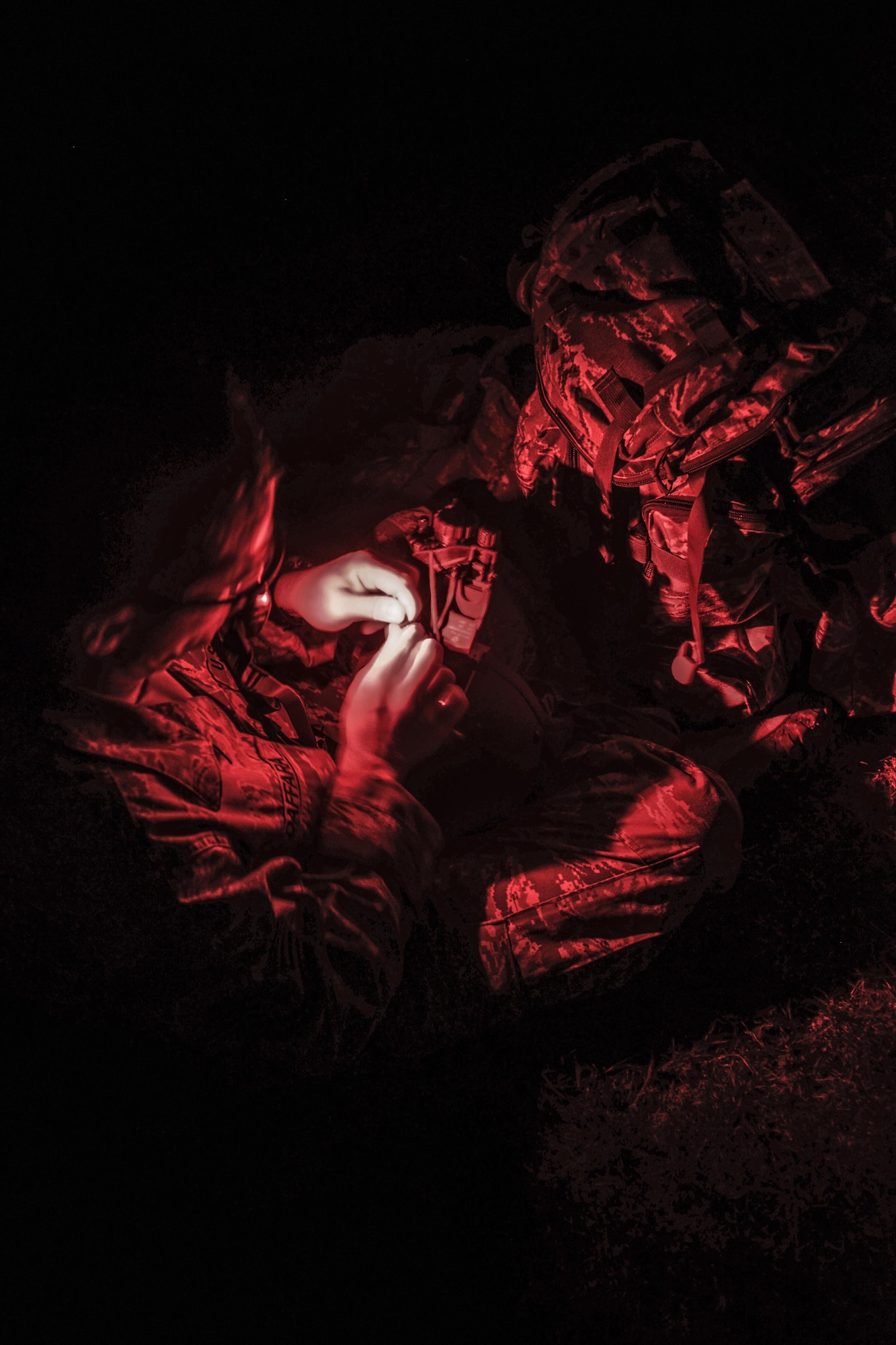 Tech Sgt. Hernan Daffara, Jungle Training Operations Course student from the 644th Combat Communications Squadron, secures a night vision monocular to his helmet during an air assault exercise June 15, 2016, at Andersen Air Force Base, Guam. Conducted by the U.S. Army 25th Infantry Division's Lightning Academy Jungle Operations Training Center from Schofield Barracks, Hawaii, and supported by 736th Security Forces Squadron Commando Warrior cadre, students prepared a simulated patient for medical evacuation. During the course, they also learned survival skills, including land navigation and evasion techniques. (U.S. Air Force photo by Tech. Sgt. Richard Ebensberger)