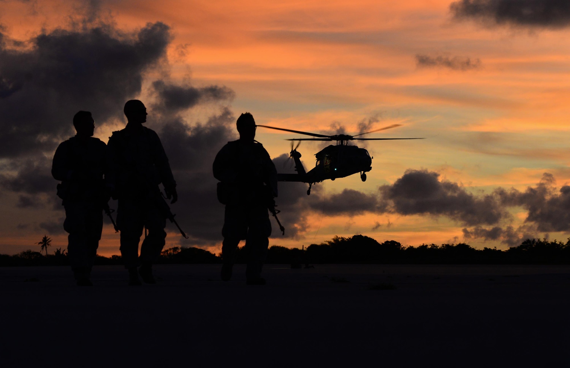 Airmen watch as an MH-60 Seahawk takes off during a jungle training course June 15, 2016, at Andersen Air Force Base, Guam. Conducted by the U.S. Army 25th Infantry Division's Lightning Academy Jungle Operations Training Center from Schofield Barracks, Hawaii, and supported by 736th Security Forces Squadron Commando Warrior cadre, students prepared a simulated patient for medical evacuation. During the course, they also learned survival skills, including land navigation and evasion techniques. (U.S. Air Force photo by Senior Airman Joshua Smoot)