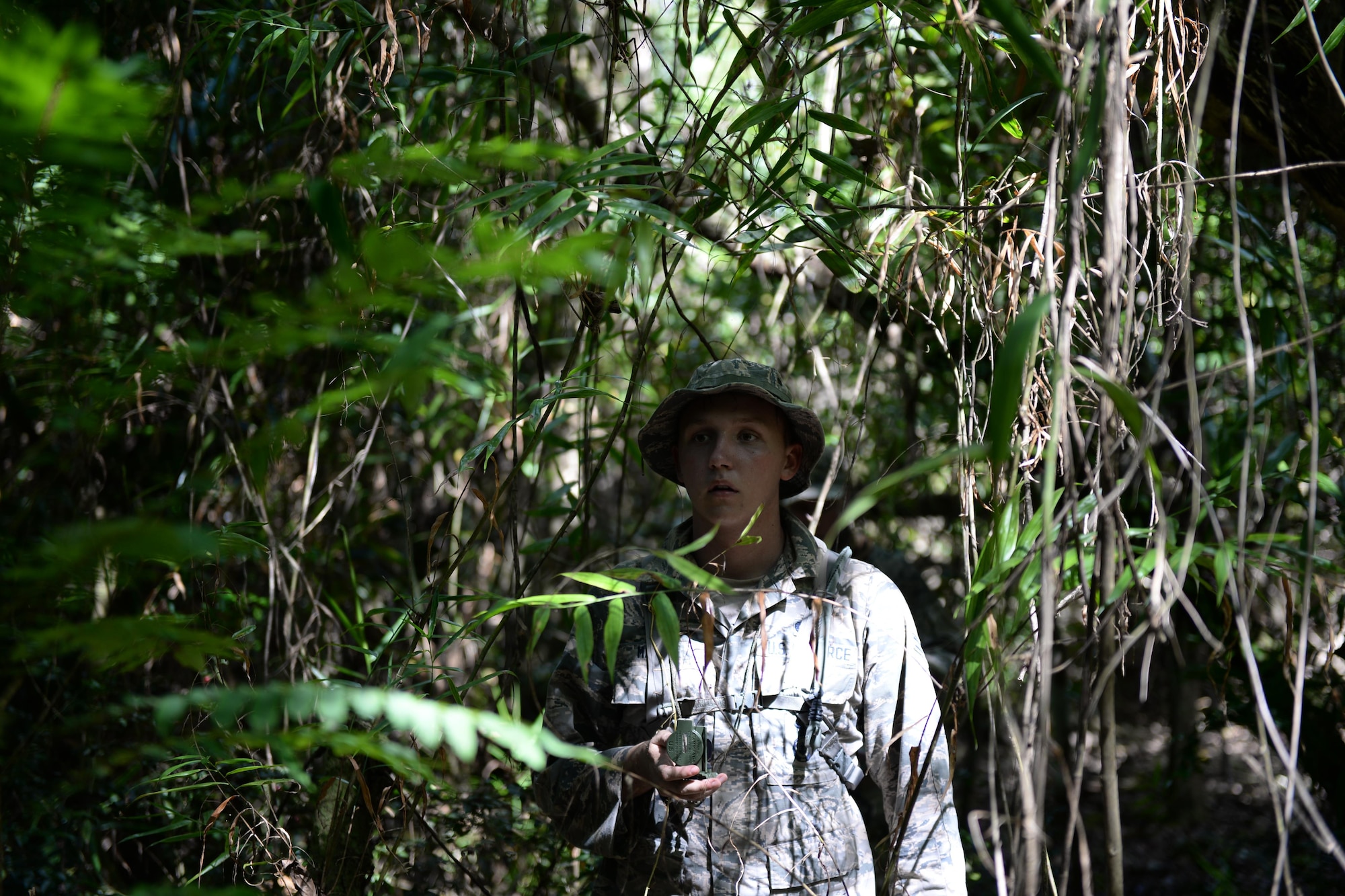 Airman 1st Class Scott Marvin, Jungle Training Operations Course student from the 36th Security Forces Squadron, navigates through the jungle using a compass June 16, 2016, in Barrigada, Guam. The trainees were individually selected from several career fields across the Department of Defense, including Airmen from the 36th Security Forces Squadron, 736th SFS, 554th RED HORSE Squadron, 644th Combat Communications Squadron and infantrymen from the 94th Army Air and Missile Defense Command’s Task Force Talon. (U.S. Air Force photo by Tech. Sgt. Richard Ebensberger)