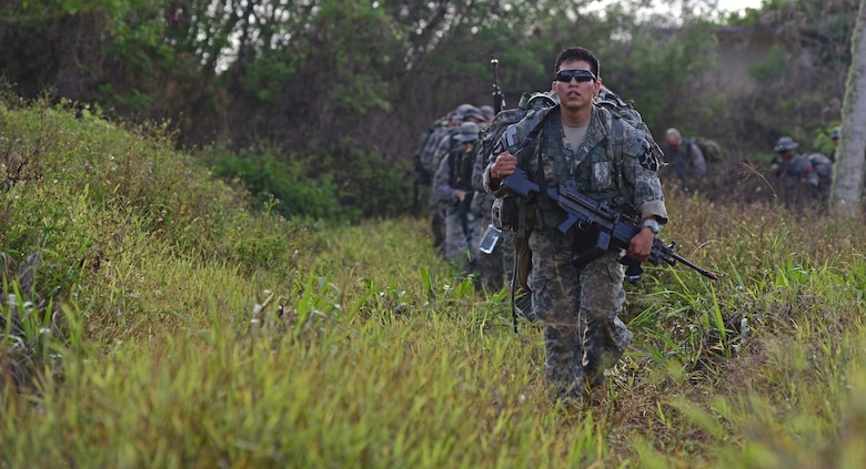 Soldiers and Airmen ruck to an objective point during the Jungle Training Operations Course June 16, 2016, in Barrigada, Guam. Conducted by the U.S. Army 25th Infantry Division's Lightning Academy Jungle Operations Training Center from Schofield Barracks, Hawaii, and supported by 736th Security Forces Squadron Commando Warrior cadre, students prepared a simulated patient for medical evacuation. During the course, they also learned survival skills, including land navigation and evasion techniques. (U.S. Air Force photo by Senior Airman Joshua Smoot)