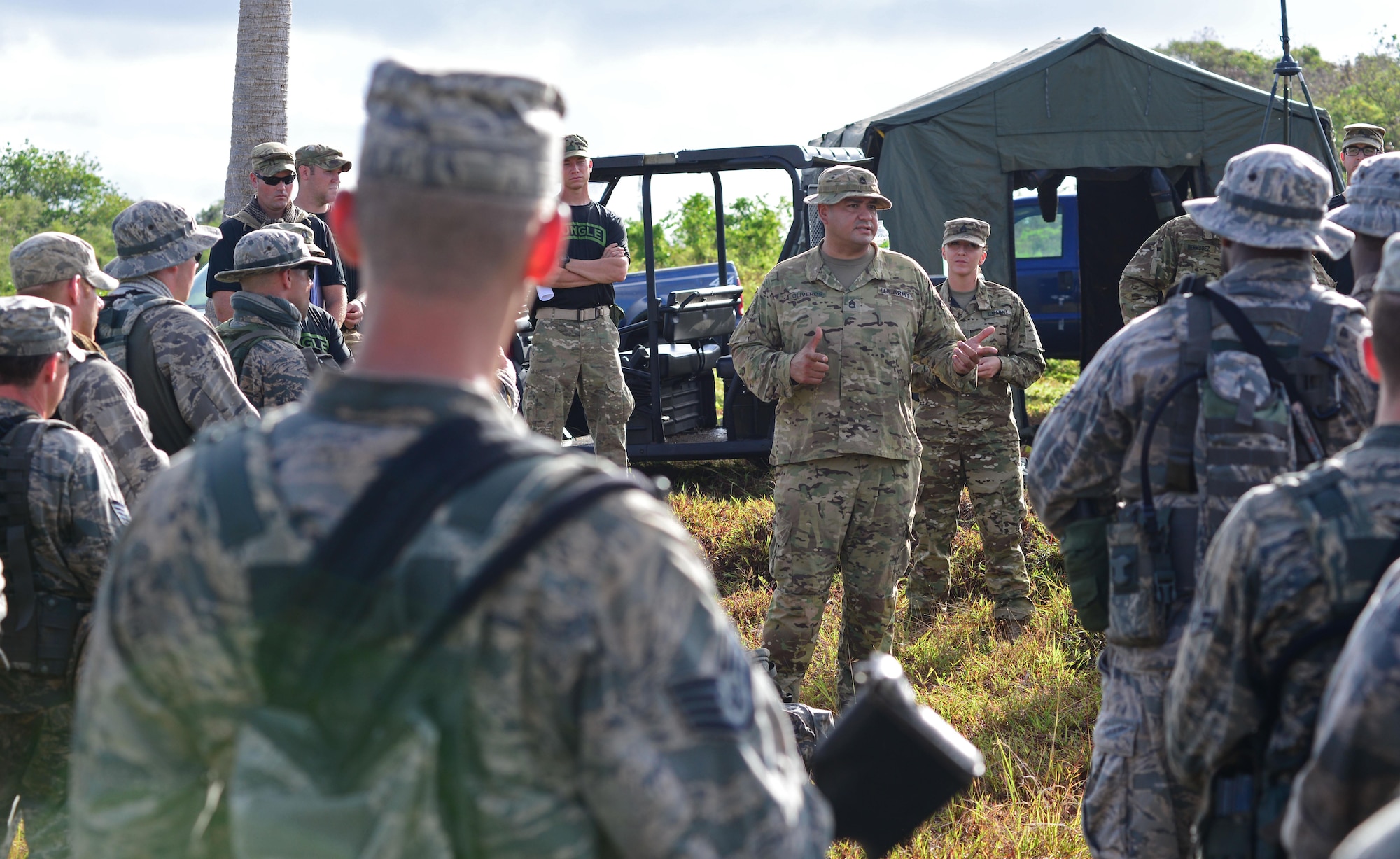 U.S. Army Sgt. 1st Class Jaime Oliveros, 25th Infantry Division’s Lightning Academy Jungle Operations Training Center instructor, informs students of their mission objectives June 16, 2016, at Andersen Air Force Base South, Guam. From June 15-21, instructors from the U.S. Army 25th Infantry Division’s Lightning Academy Jungle Operations Training Center, in Schofield Barracks, Hawaii, travelled to Guam to teach more than 30 Airmen and Soldiers the fundamentals of fighting and surviving in jungles with support from cadre members of the 736th Security Forces Squadron. (U.S. Air Force photo by Senior Airman Joshua Smoot)