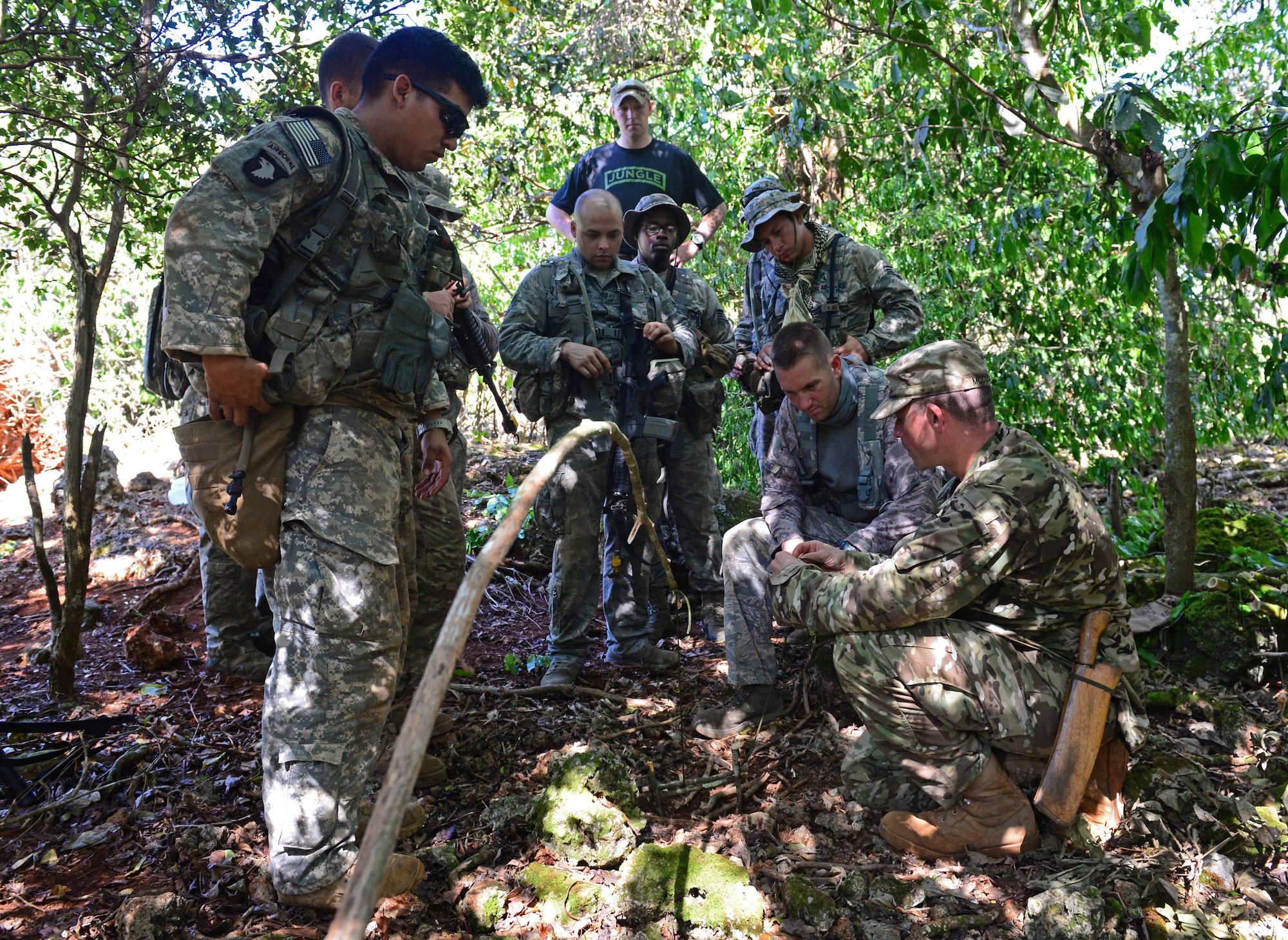 Airmen and Soldiers learn how to set animal traps and snares during the Jungle Training Operations Course June 17, 2016, at Andersen Air Force Base, Guam. From June 15-21, instructors from the U.S. Army 25th Infantry Division’s Lightning Academy Jungle Operations Training Center, in Schofield Barracks, Hawaii, travelled to Guam to teach more than 30 Airmen and Soldiers the fundamentals of fighting and surviving in jungles with support from cadre members of the 736th Security Forces Squadron. (U.S. Air Force photo by Senior Airman Joshua Smoot)