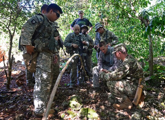 Airmen and Soldiers learn how to set animal traps and snares during the Jungle Training Operations Course June 17, 2016, at Andersen Air Force Base, Guam. From June 15-21, instructors from the U.S. Army 25th Infantry Division’s Lightning Academy Jungle Operations Training Center, in Schofield Barracks, Hawaii, travelled to Guam to teach more than 30 Airmen and Soldiers the fundamentals of fighting and surviving in jungles with support from cadre members of the 736th Security Forces Squadron. (U.S. Air Force photo by Senior Airman Joshua Smoot)