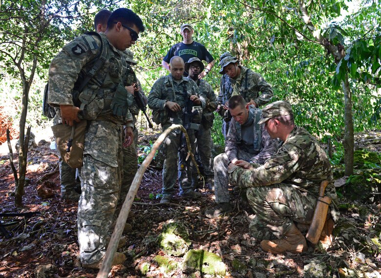 Airmen and Soldiers learn how to set animal traps and snares during the Jungle Training Operations Course June 17, 2016, at Andersen Air Force Base, Guam. From June 15-21, instructors from the U.S. Army 25th Infantry Division’s Lightning Academy Jungle Operations Training Center, in Schofield Barracks, Hawaii, travelled to Guam to teach more than 30 Airmen and Soldiers the fundamentals of fighting and surviving in jungles with support from cadre members of the 736th Security Forces Squadron. (U.S. Air Force photo by Senior Airman Joshua Smoot)