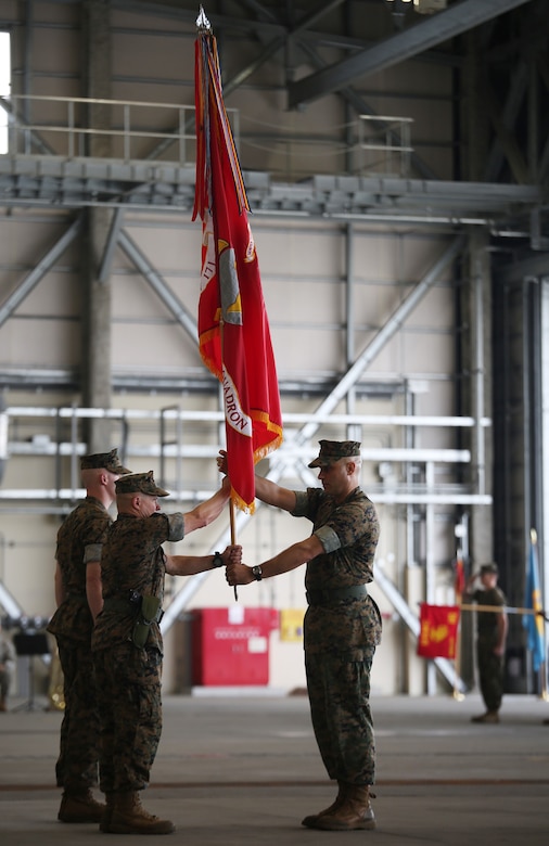 U.S. Marine Corps Sgt. Maj. Jonathan M. Wyble, left, Marine Wing Support Squadron (MWSS) 171 sergeant major, passes the squadron guidon to Lt. Col. James S. Whiteker, outgoing commanding officer of MWSS-171, during a change of command ceremony at Marine Corps Air Station Iwakuni, Japan, June 30, 2016. After serving honorably and faithfully for two years as the squadron commander, Whiteker will be moving onto his next assignment at U.S. Marine Corps Forces South in Miami, Florida, as the logistics officer. (U.S. Marine Corps Photo by Sgt. Jessica Quezada/Released)
