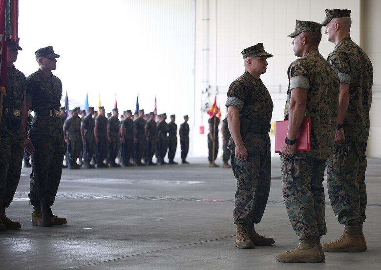 U.S. Marine Corps. Lt. Col. James S. Whiteker, center, Marine Wing Support Squadron (MWSS) 171 commanding officer, receives a meritorious service medal gold star in lieu of a fourth award from Col. Daniel Shipley, right, Marine Aircraft Group 12 commanding officer,  during a change of command ceremony at Marine Corps Air Station Iwakuni, Japan, June 30, 2016. Whiteker relinquished his duties as MWSS-171 commanding officer to Lt. Col. Jason B. Berg after serving as the squadron commander for two years. Previously serving as the commanding officer for Combat Logistics Company 36 at MCAS Iwakuni back in January 2008, Whiteker assumed leadership of MWSS-171 in June 2014 and will be moving to his next assignment at U.S. Marine Corps Forces South in Miami, Florida, as the logistics officer.  (U.S. Marine Corps Photo by Sgt. Jessica Quezada/Released)