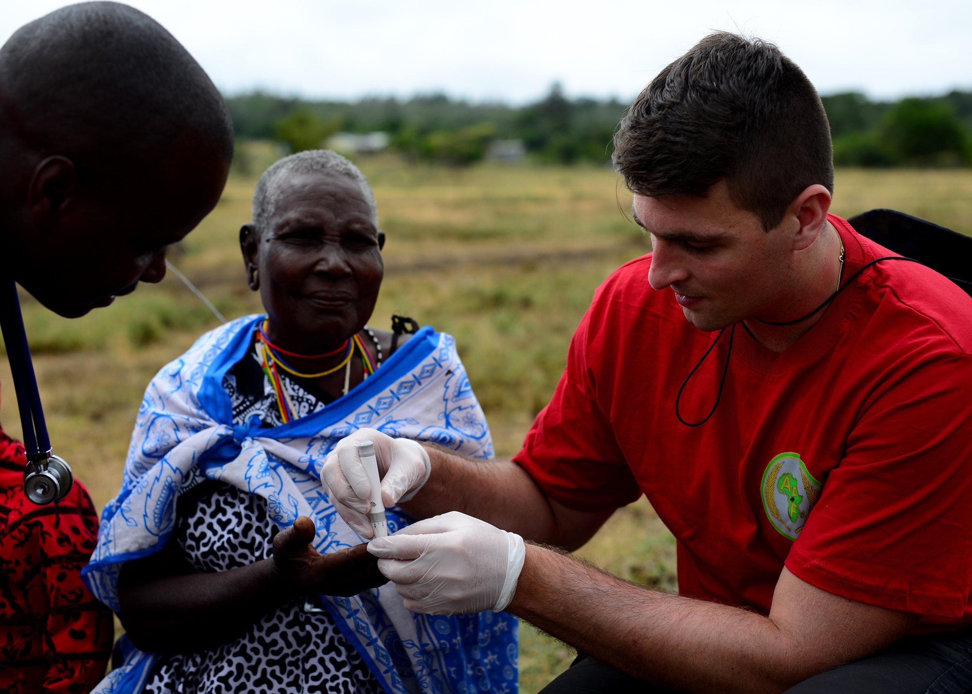 U.S. Air Force Capt. Andrew Christo, 104th Fighter Wing Massachusetts Air National Guard registered nurse, cares for a patient during medical outreach June 22, 2016 at Lokusero, Kenya.  The medical outreach was part of the first African Partnership Flight in Kenya. Over the course of three days, medical assistance was provided for more than 1,250 patients. The APF is designed for U.S. and African partner nations to work together in a learning environment to help build expertise and professional knowledge and skills. (U.S. Air Force photo by Tech. Sgt. Evelyn Chavez/Released)