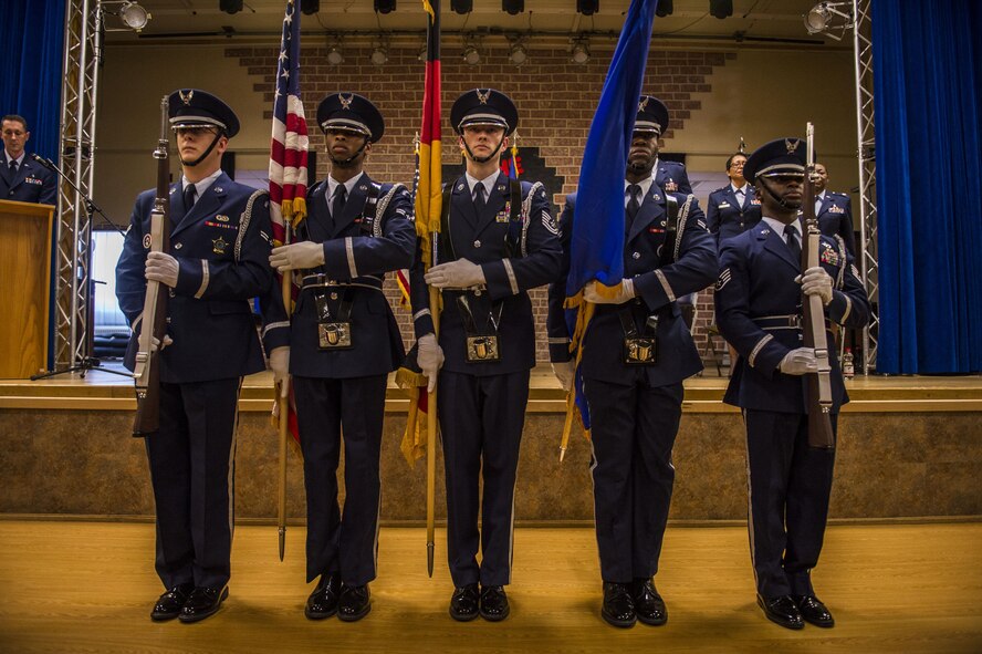 A Spangdahlem Air Base ceremonial guardsmen detail present the colors during the 52nd Medical Operations Squadron change of command ceremony at the Brickhouse on Spangdahlem Air Base, Germany, June 29, 2016. It is tradition for the guardsmen to post both the United States and the host nation’s flags depending on where they are stationed. (U.S. Air Force photo by Senior Airman Luke Kitterman/Released)