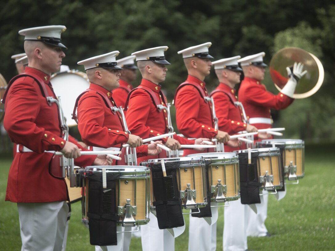 The United States Marine Drum and Bugle Corps performs during a Tuesday Sunset Parade at the Marine Corps War Memorial in Arlington, Va., Jun. 28, 2016. Dr. Rory Cooper, director of Human Engineering Research Laboratories, was the guest of honor and Sgt. Maj. Ronald Green, sergeant major of the Marine Corps, served as the hosting official. This parade featured noncommissioned officers in positions traditionally held by officers and staff NCOs. (Official Marine Corps photo by Cpl. Chi Nguyen/Released)