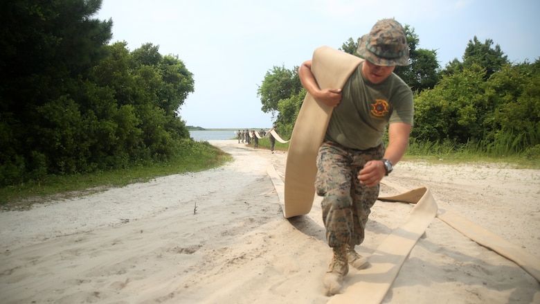 A Marine with Bulk Fuel Company, 8th Engineer Support Battalion, assists in setting up an amphibious assault fuel system at Marine Corps Base Camp Lejeune, North Carolina, June 24, 2016.  A completed AAFS can hold approximately 1.12 million gallons of fuel, which is capable of supporting an entire Marine Expeditionary Force. 