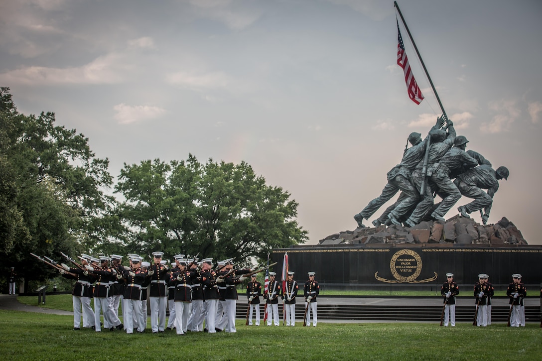 The 18th Sergeant Major of the Marine Corps, Ronald L. Green, hosts a Sunset Parade at the Marine Corps War Memorial, Arlington, VA., June 28, 2016. The parade's Guest of Honor was Dr. Rory Cooper, and included performances from the Marine Drum and Bugle Corps and the Silent Drill Platoon. (U.S. Marine Corps photo by Sgt. Melissa Marnell, Office of the Sergeant Major of the Marine Corps/Released)