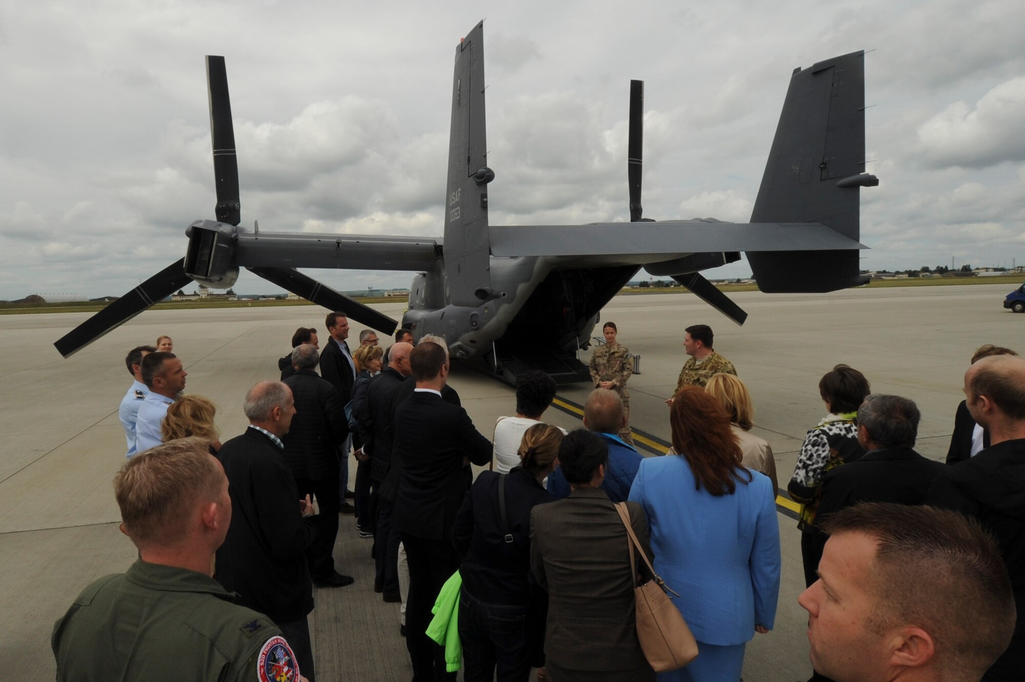 Local German community leaders view a CV-22 Osprey tilt-rotor aircaft assigned to the 352nd Special Operations Wing during a presentation on the flightline near the 726th Air Mobility Squadron at Spangdahlem Air Base, Germany, June 28, 2016. The 352nd SOW, currently stationed at Royal Air Force Mildenhall, United Kingdom, will relocate to Spangdahlem as part of the European Infrastructure Consolidation realignment slated over the coming years. (U.S. Air Force Photo by Staff Sgt. Joe W. McFadden/Released)