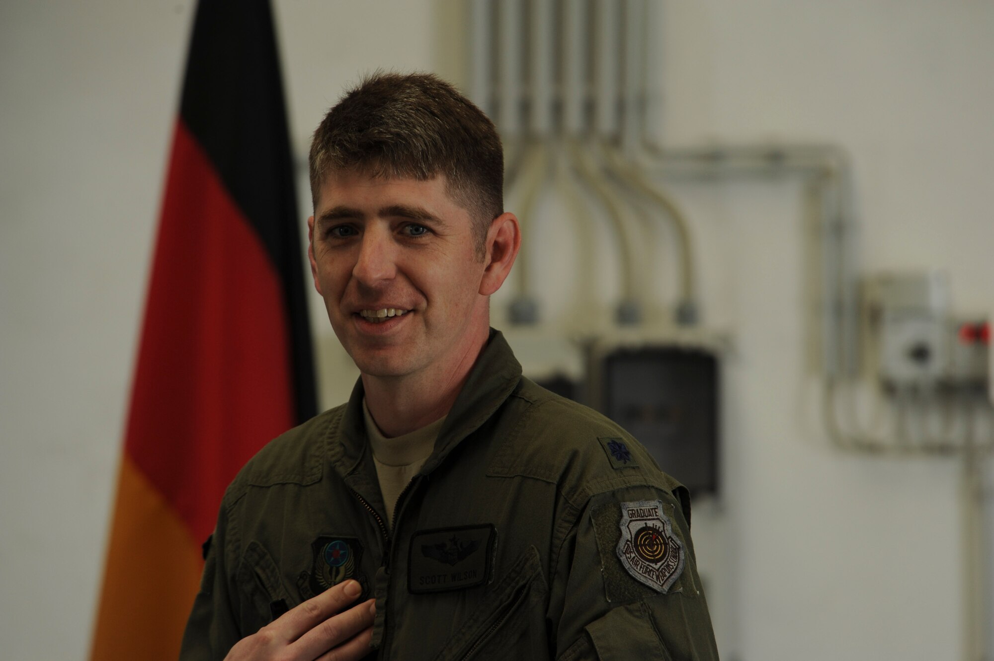 U.S. Air Force Lt. Col. Scott Wilson, 352nd Special Operations Wing director of staff, gives a presentation about CV-22 Osprey tilt-rotor aircaft assigned to his wing during a presentation to local German community leaders on the flightline near the 726th Air Mobility Squadron at Spangdahlem Air Base, Germany, June 28, 2016. The 352nd SOW, currently stationed at Royal Air Force Mildenhall, United Kingdom, will relocate to Spangdahlem as part of the European Infrastructure Consolidation realignment slated over the coming years. (U.S. Air Force Photo by Staff Sgt. Joe W. McFadden/Released)