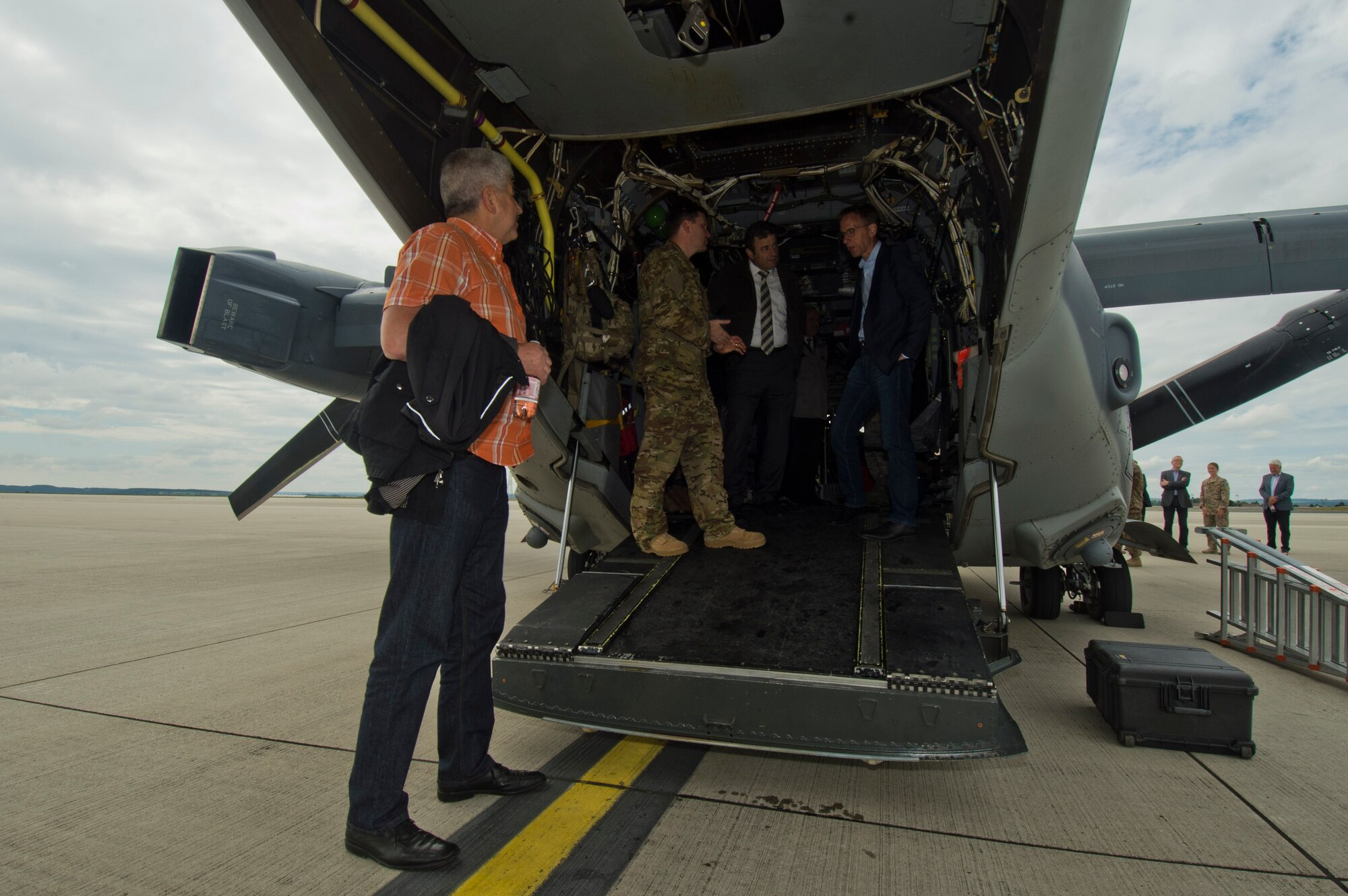 Local German community leaders view a CV-22 Osprey tilt-rotor aircaft assigned to the 352nd Special Operations Wing during a presentation on the flightline near the 726th Air Mobility Squadron at Spangdahlem Air Base, Germany, June 28, 2016. The 352nd SOW, currently stationed at Royal Air Force Mildenhall, United Kingdom, will relocate to Spangdahlem as part of the European Infrastructure Consolidation realignment slated over the coming years. (U.S. Air Force Photo by Staff Sgt. Joe W. McFadden/Released)