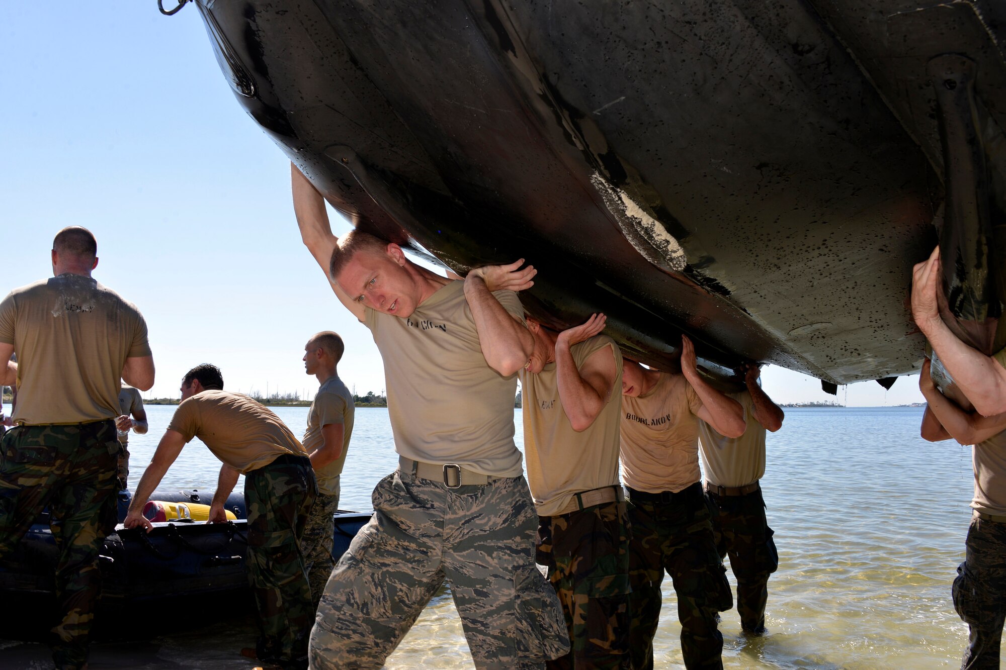 Special Tactics officer candidates carry a Zodiac boat to the shore during a selection at Hurlburt Field, Fla., Oct. 21, 2014. Special Tactics career field training pipelines are some of the most physically and psychologically challenging in the Air Force. To ensure the correct individuals are on the battlefield, a group of Special Tactics Airmen weed out the cross-training candidates who don’t meet the high standards, putting them through a week-long selection process to select only the best-qualified individuals. (U.S. Air Force photo by 1st Lt. Katrina Cheesman) 