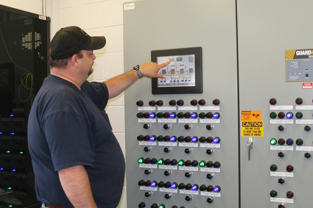 Gerald Kirkbride, wastewater treatment plant supervisor, demonstrates how the new treatment plant at Camp Upshur on Marine Corps Base Quantico’s west side can be operated completely by the touch of a button. The new plant has been online since June 6 and replaces a plant that had been operational for 65 years.