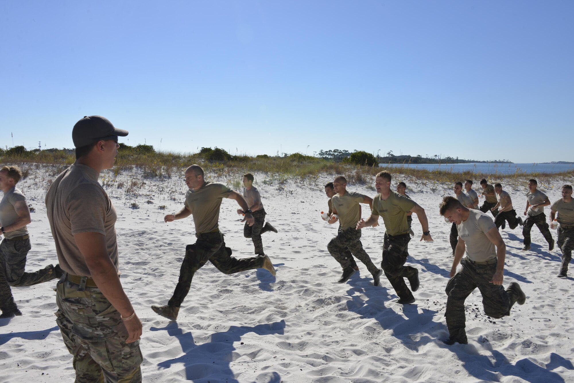 A Recruitment, Assesment and Selection cadre yells commands at Special Tactics officer candidates during a selection at Hurlburt Field, Fla., Oct. 21, 2014. Special Tactics career field training pipelines are some of the most physically and psychologically challenging in the Air Force. To ensure the correct individuals are on the battlefield, a group of Special Tactics Airmen weed out the cross-training candidates who don’t meet the high standards, putting them through a week-long selection process to select only the best-qualified individuals. (U.S. Air Force photo by 1st Lt. Katrina Cheesman) 