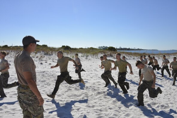 A Recruitment, Assessment and Selection cadre member yells commands at special tactics officer candidates during a selection at Hurlburt Field, Fla., Oct. 21, 2014. Special tactics career field training pipelines are some of the most physically and psychologically challenging in the Air Force. To ensure the correct individuals are on the battlefield, a group of special tactics Airmen weed out the cross-training candidates who don’t meet the high standards, putting them through a weeklong selection process to select only the best-qualified individuals. (U.S. Air Force photo/1st Lt. Katrina Cheesman)   