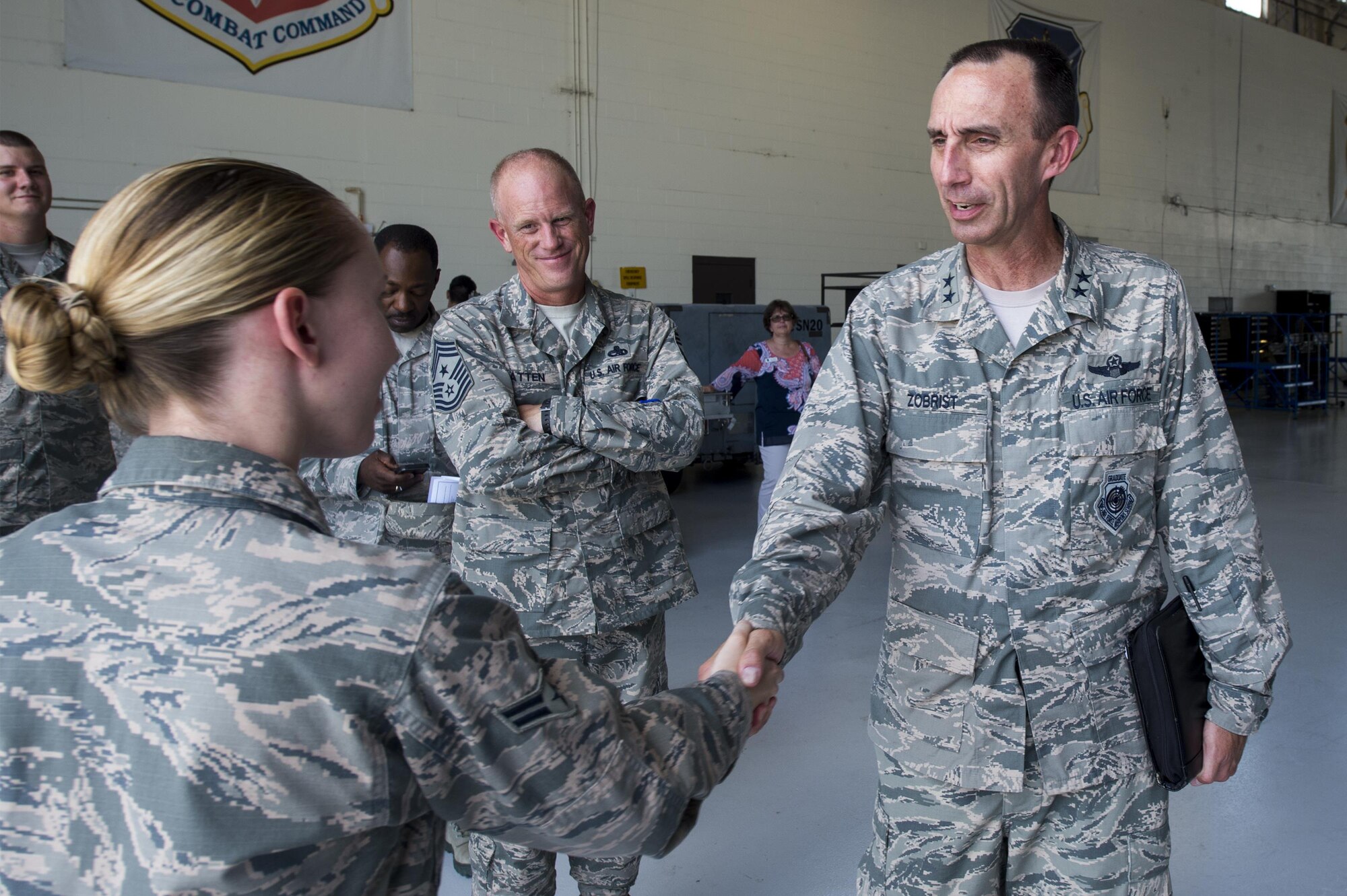 U.S. Air Force Maj. Gen. Scott Zobrist, Ninth Air Force commander, coins Airman 1st Class Felicia Anderson, 23d Aircraft Maintenance Squadron crew chief, during his visit, June 28, 2016, at Moody Air Force Base, Ga. Zobrist recognized Anderson as the 23d AMXS’s newest Below-the-Zone winner. (U.S. Air Force photo by Senior Airman Ceaira Young/Released)