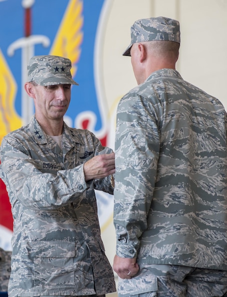U.S. Air Force Maj. Gen. Scott Zobrist, Ninth Air Force commander, presents the Legion of Merit Award to Col. Joseph Locke, 93d Air Ground Operations Wing outgoing commander, during a change of command ceremony, June 28, 2016, at Moody Air Force Base, Ga. Locke was awarded the Legion of Merit for his leadership efforts that saved countless lives and earned the unit honors such as the Air Force Outstanding Unit Award in 2015. (U.S. Air Force photo by Senior Airman Ceaira Young/Released)