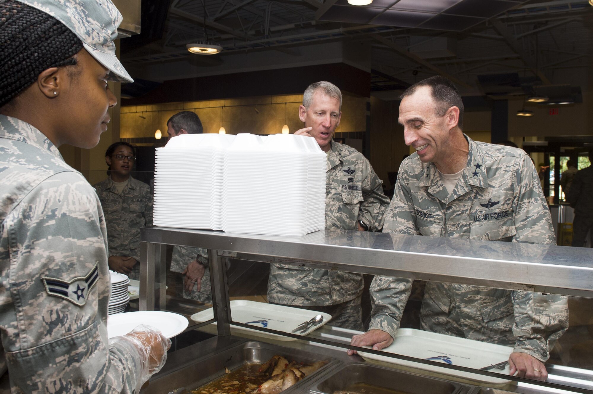 U.S. Air Force Airman 1st Class Shakilah Bates, 23d Force Support Squadron food service specialist, serves food to Maj. Gen. Scott Zobrist, Ninth Air Force commander, during his visit to the Georgia Pines Dining Facility, June 28, 2016, at Moody Air Force Base, Ga. Zobrist toured Moody’s facility designed by and for Airmen to experience first-hand some of the resources available to Airmen. (U.S. Air Force photo by Senior Airman Ceaira Young/Released)