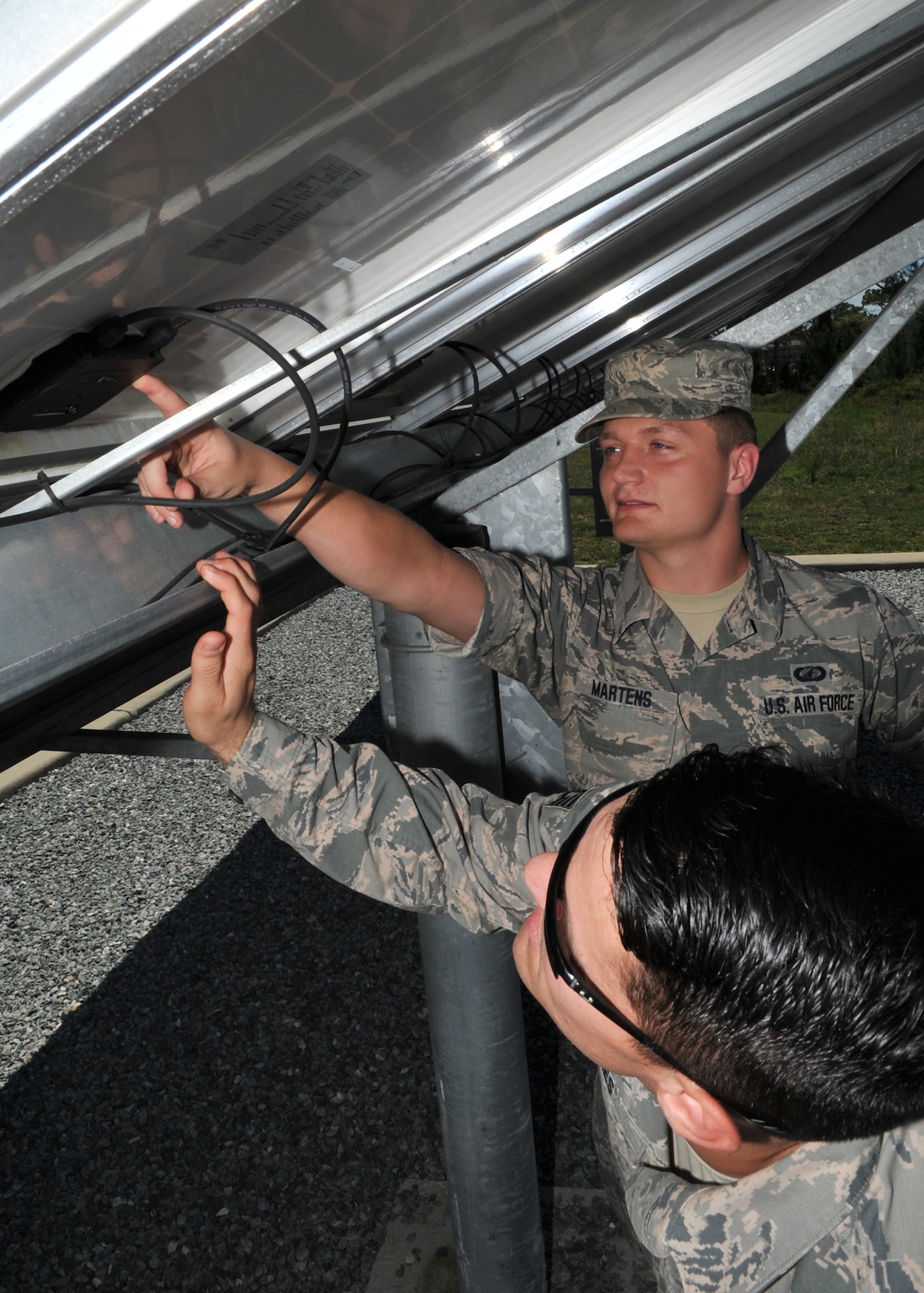 Staff Sgt. Gregory Jones, 772nd Enterprise Sourcing Squadron energy, construction and air conditioning NCO in-charge and Senior Airman Zachary Martens, 772nd ESS contracting specialist, inspect the components of a solar panel at the Air Force Civil Engineer Center, June 23, 2016. A 772nd ESS contractor’s duties typically include performing these inspections to ensure that purchased equipment meet government standards. (U.S. Air Force photo by Senior Airman Ty-Rico Lea/Released)