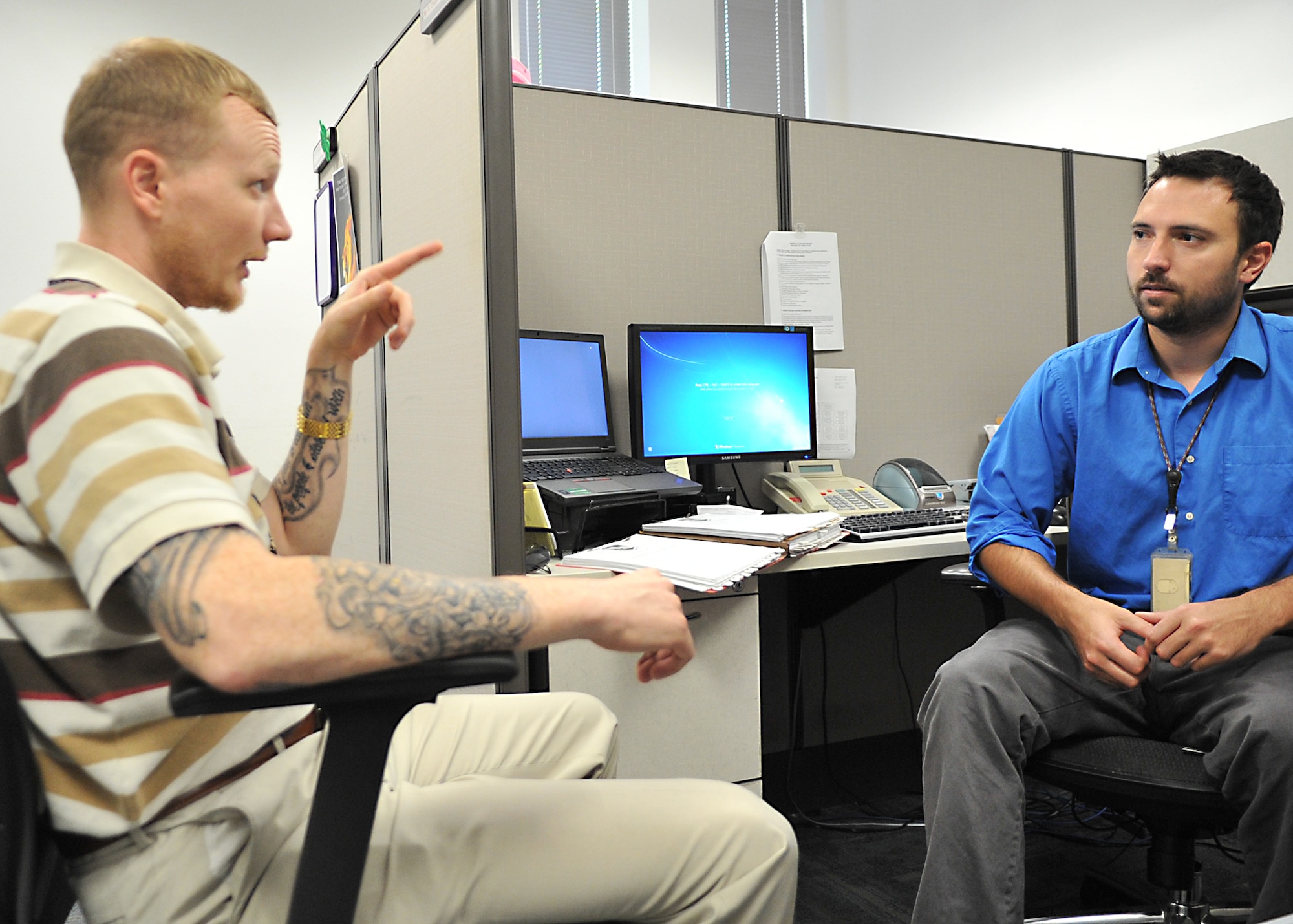 Jared Dwyer and Chase Cooper, 772nd Enterprise Sourcing Squadron contracting officers, discuss acquisition strategies for Explosive Ordnance Disposal equipment at the Air Force Civil Engineer Center, June 23, 2016. The squadron has a combined total 33 personnel currently assigned to it this includes both military and civil service personnel. (U.S. Air Force photo by Senior Airman Ty-Rico Lea/Released)