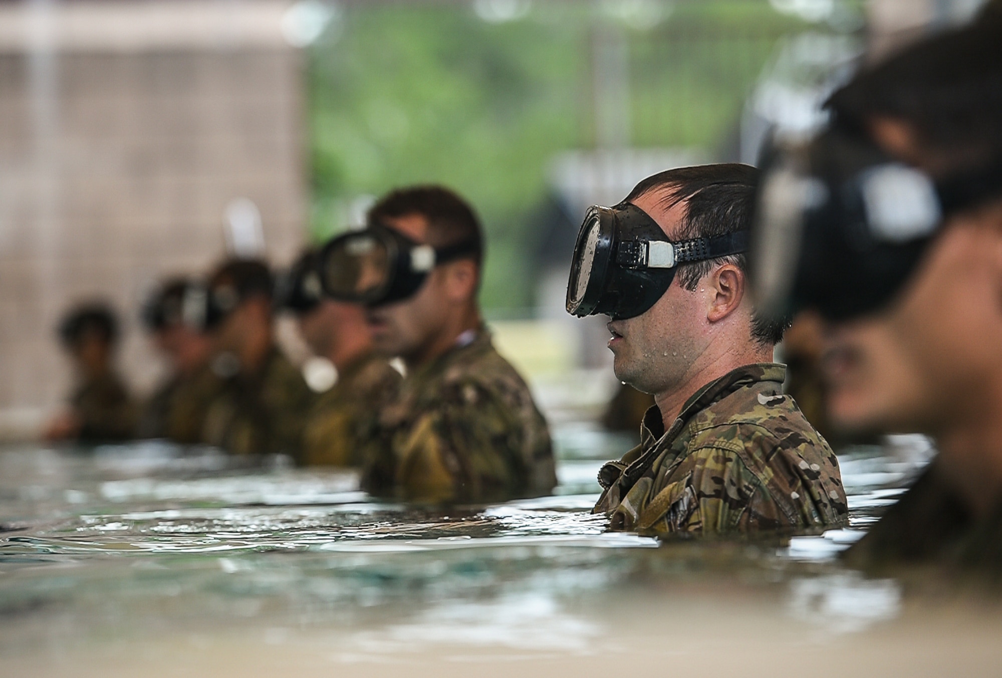 Special Tactics Training Squadron students line up during a pre-scuba class at Hurlburt Field, Fla., June 29, 2016. The training familiarizes trainees with the basics of water operations. The trainees perform tasks such as tying knots underwater, learning how to stay afloat without their arms and hands, and how to use snorkeling gear. Special Tactics students later apply this knowledge to combat dive training. This training also reproduces physiological effects similar those experienced on the battlefield, and thus builds the necessary mental resiliency for ground special operations force. (U.S. Air Force photo by Senior Airman Ryan Conroy) 