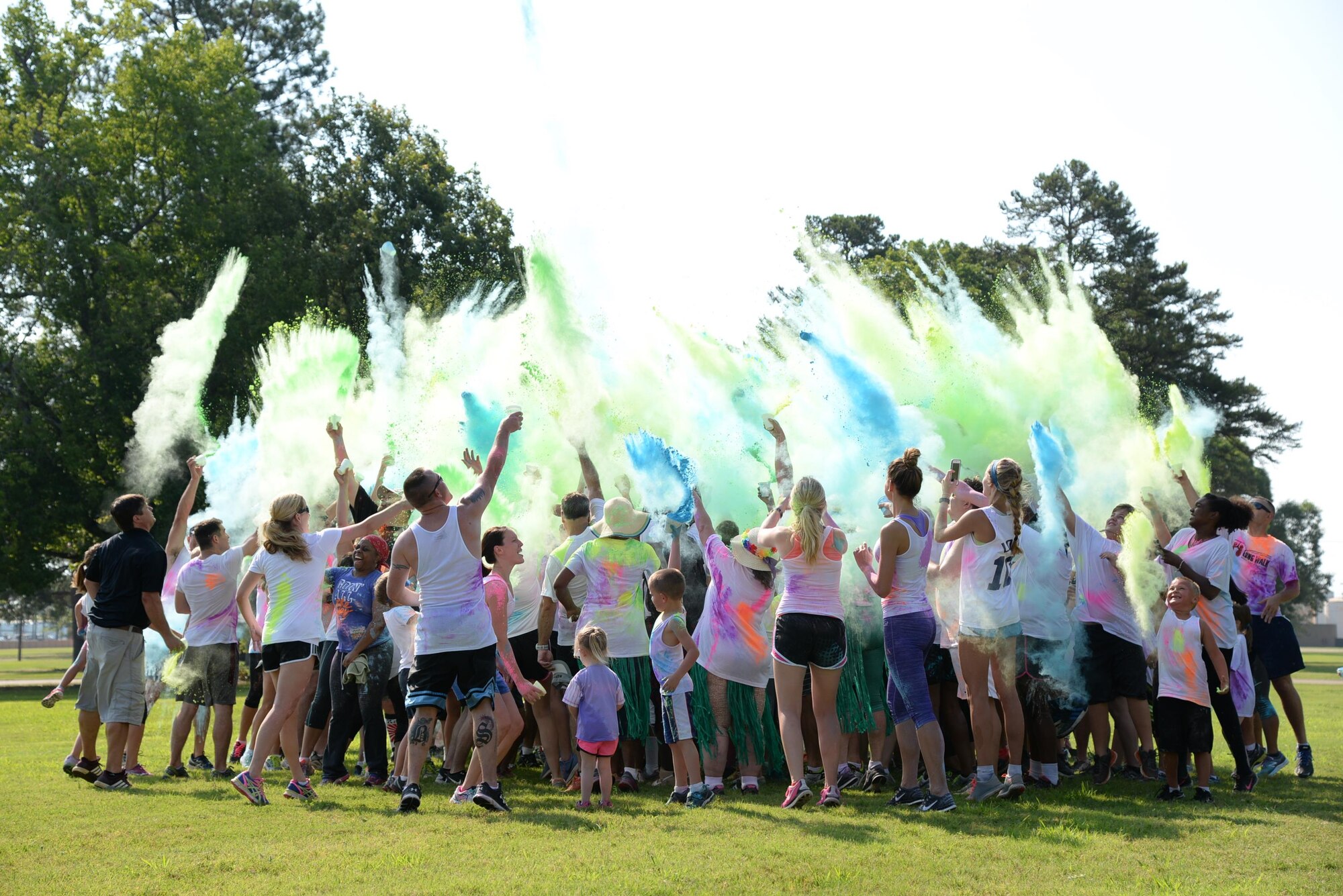 Participants in the fourth annual Color Run celebrate the completion of the race by throwing the remaining chalk colors into the air June 25 at Columbus Air Force Base, Mississippi. Over 240 participants from the base and local community participated in the Color Run 5k or two-mile run where they ran through colored chalk thrown in their path. (U.S. Air Force photo/Airman 1st Class John Day)