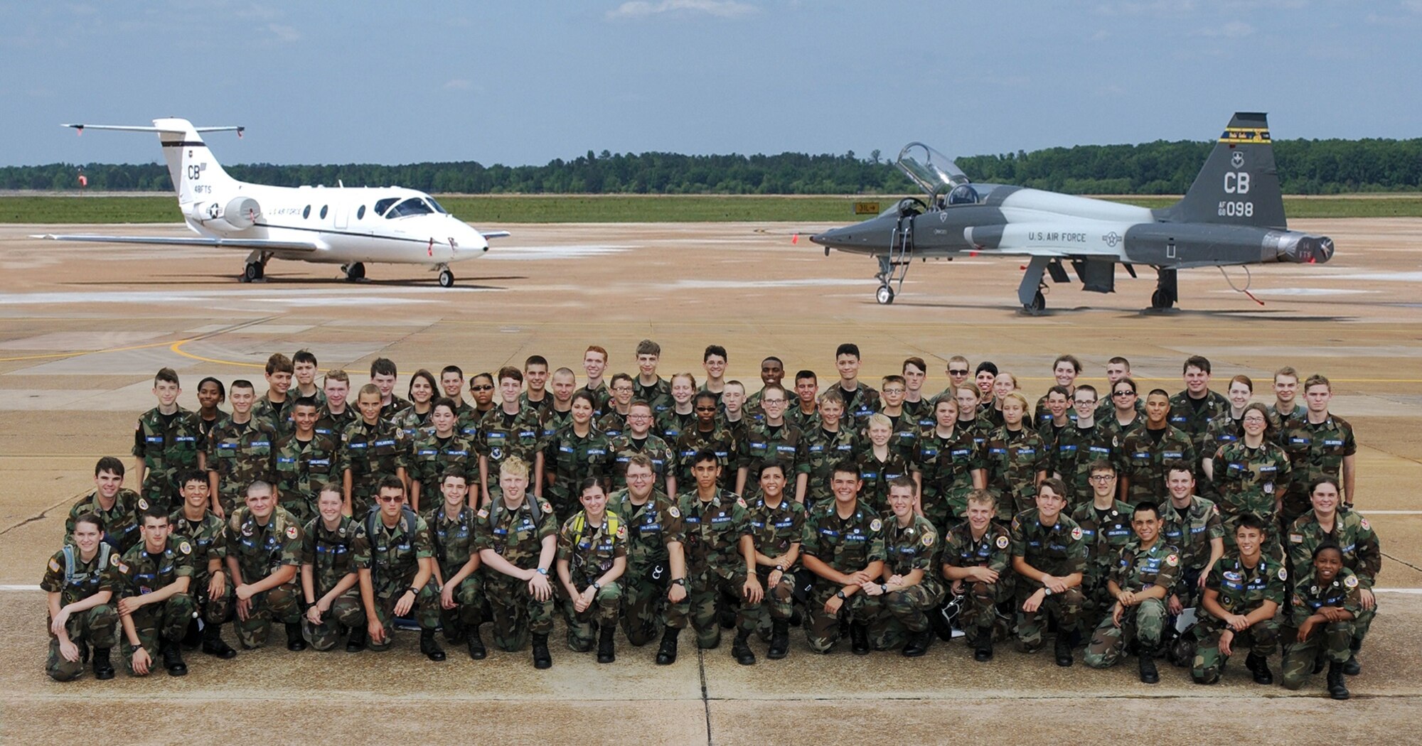 Civil Air Patrol cadets pause on the flightline for a photo with the T-1A Jayhawk and T-38C Talon June 27 Columbus Air Force Base, Mississippi. CAP members toured the base visiting various areas including the Air Traffic Control tower, the enlisted dorms, the aerospace physiology flight, the security forces squadron and the McAllister Fire Station. (U.S. Air Force photo/Sharon Ybarra)